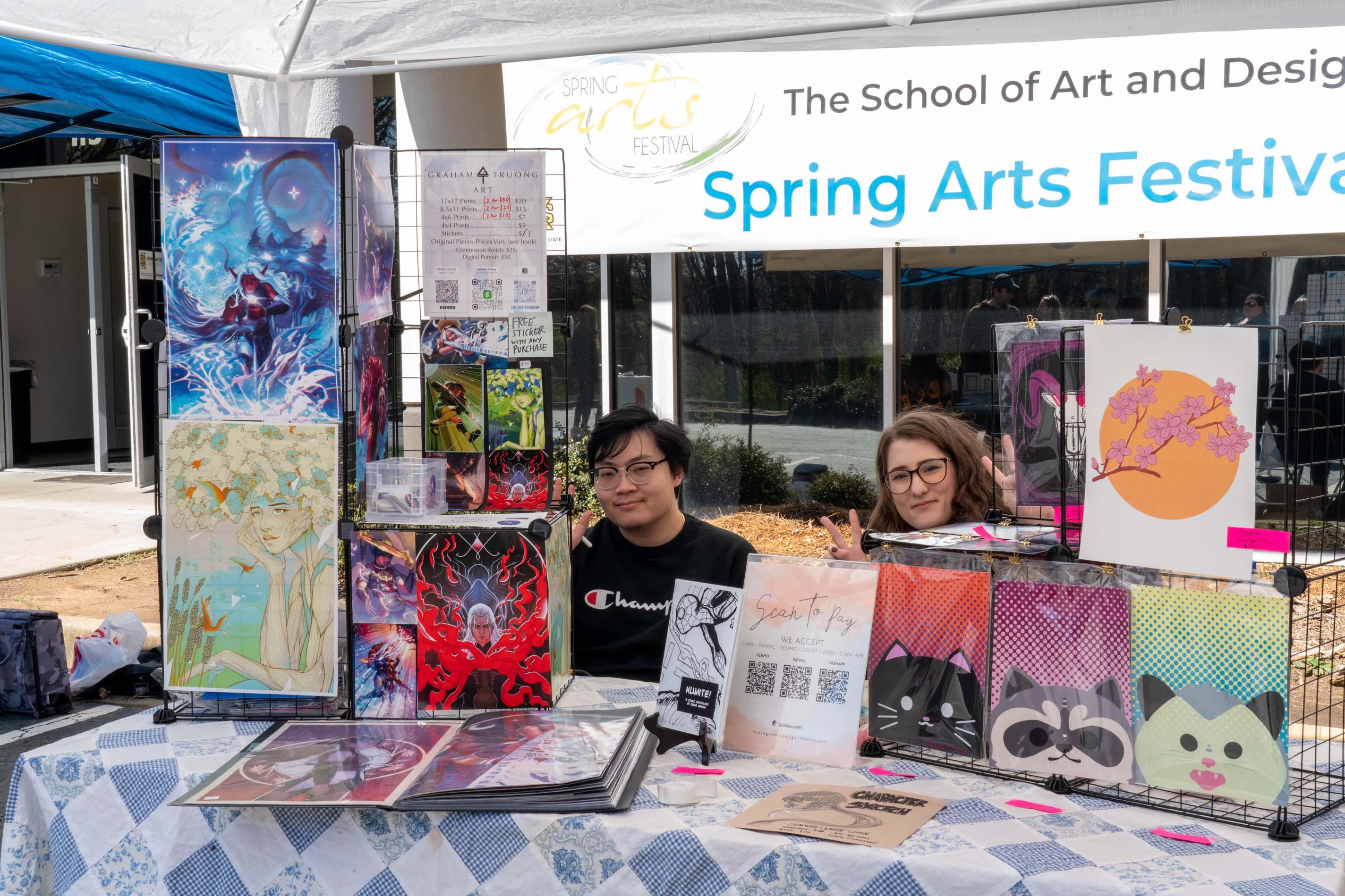  / Alumni Graham Truong (left) and Andy Hollingworth (right) and their table at the 2023 Spring Arts Festival  

