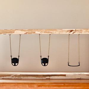 Boxed Up Dreams  / Boxed Up Dreams (2025). Mixed Media Sculpture: Reclaimed wood, chain, toddler and belt swings designed in Tinkercad and 3D printed  