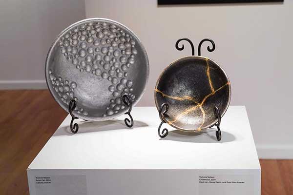 Victoria Nelson, "Amor Fati", 2024. Cast Aluminum. Victoria Nelson, "Childhood", 2024. Cast Iron, Epoxy Resin and Gold Mica Powder.  / 