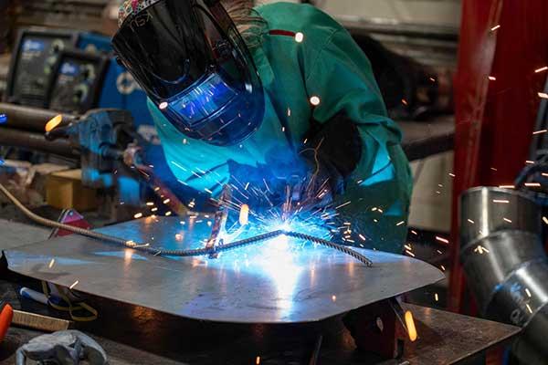 Student Abby Bester welding.  / 