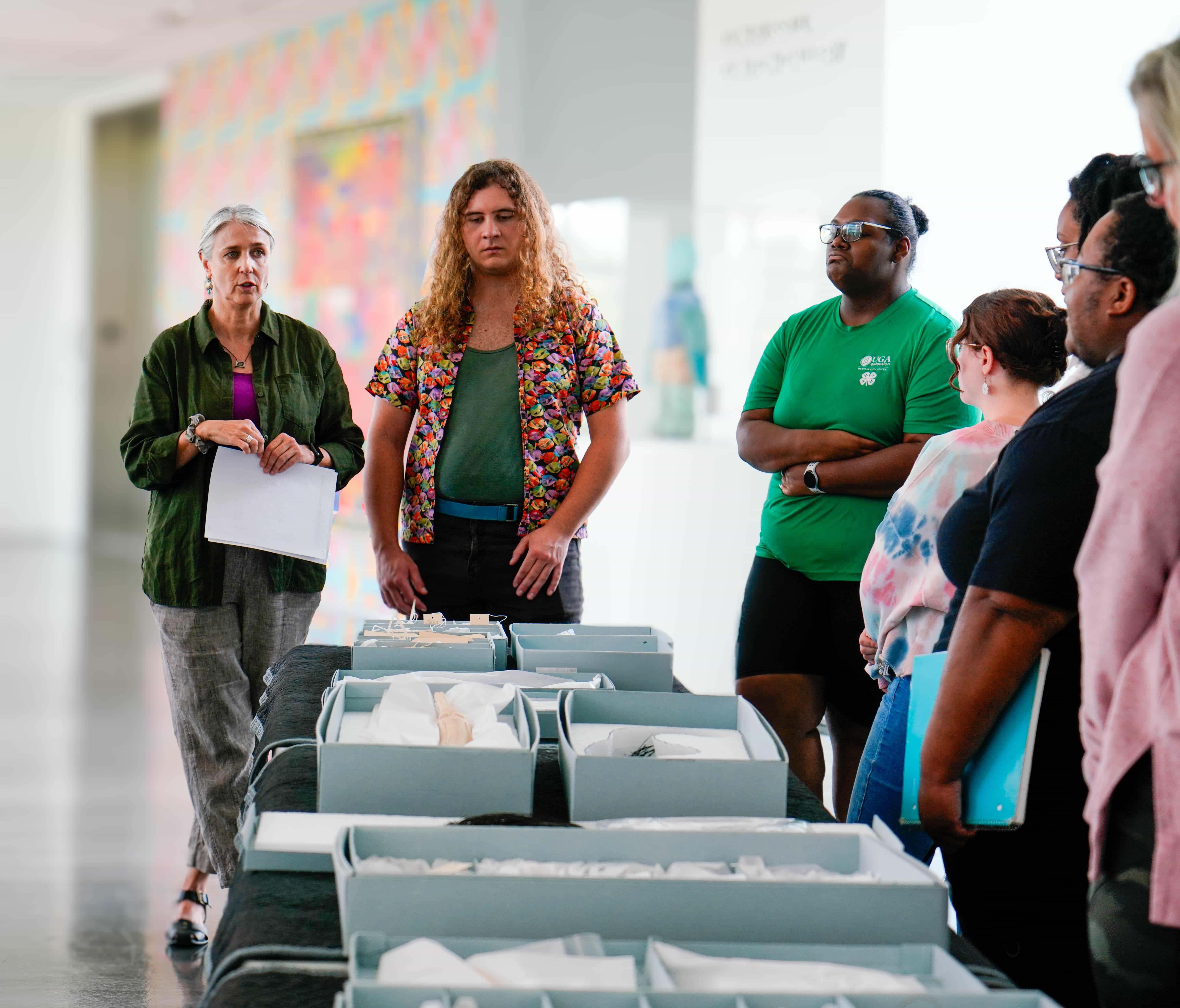  / Students studying the Zuckerman Museum of Art's African ivory collection. 
Students studying the Zuckerman Museum of Art's African ivory collection. 
