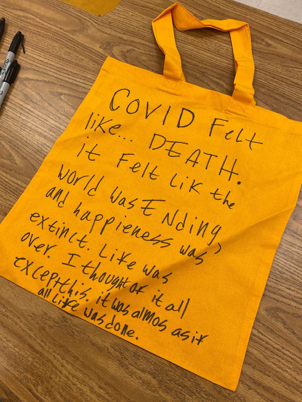 Thesis 1 / A yellow paper with handwritten text clipped to a string with a clothespin.