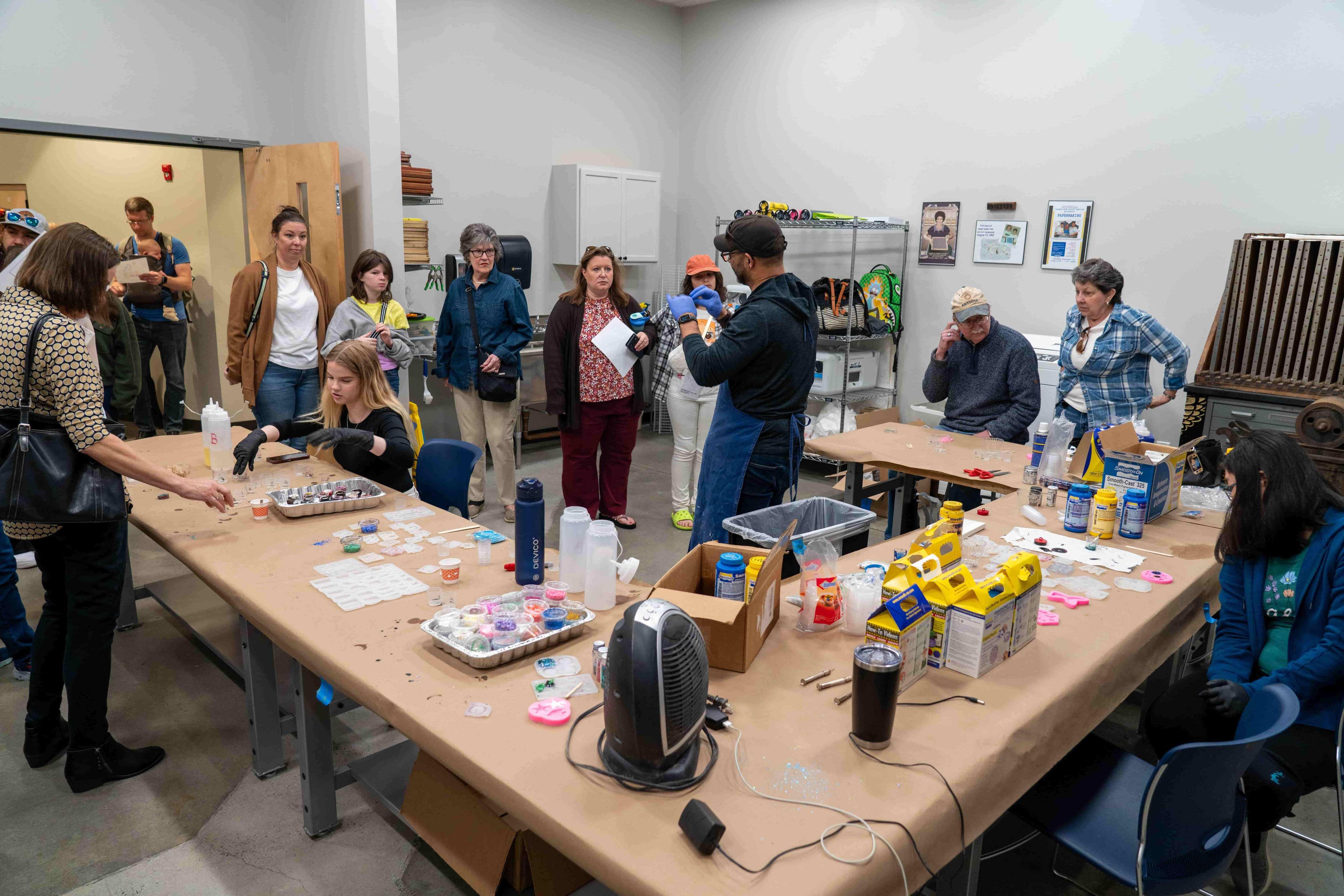 K-12 students and parents creating quick set resin art.  / 