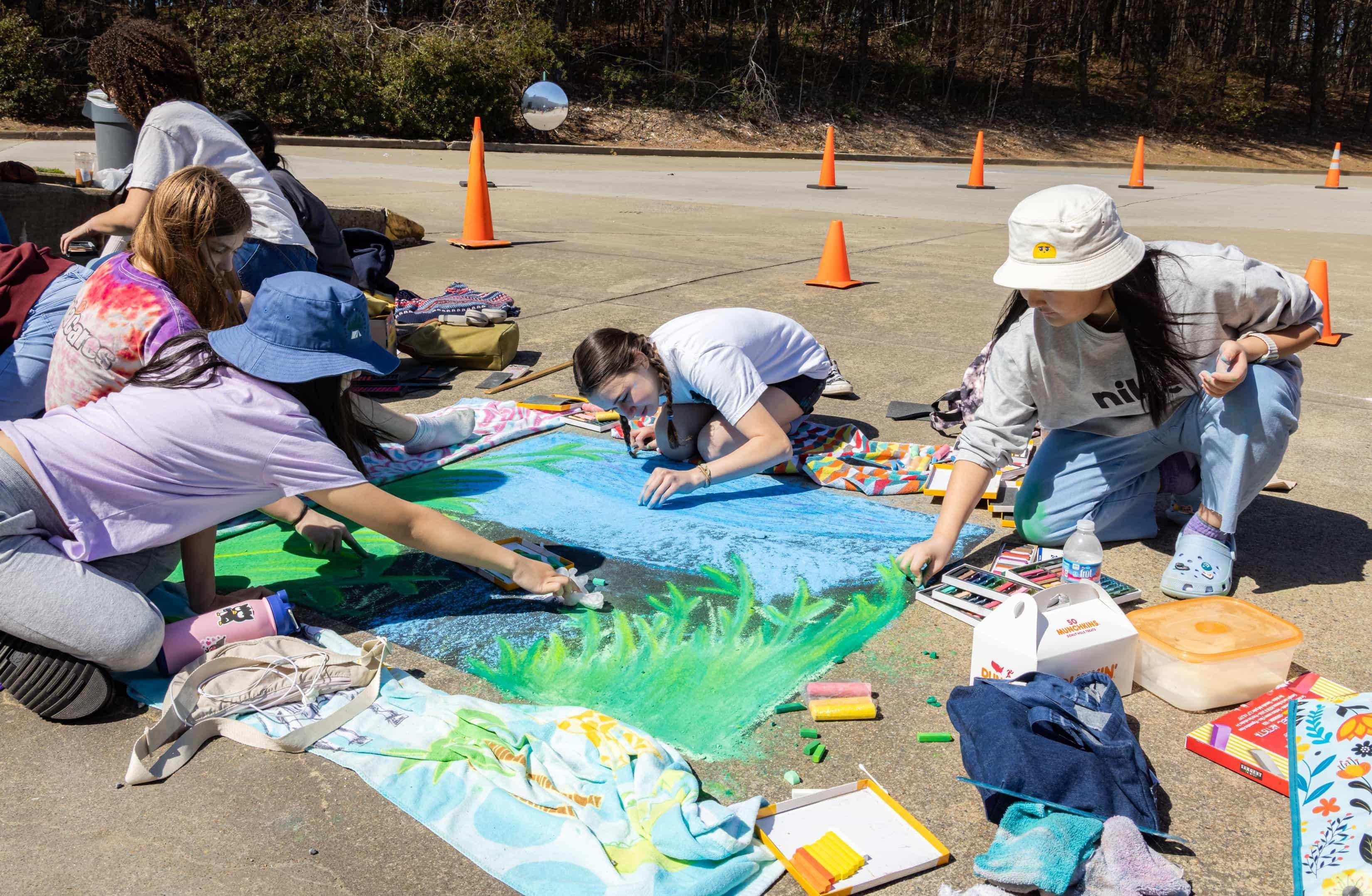 K-12 students creating chalk art / 