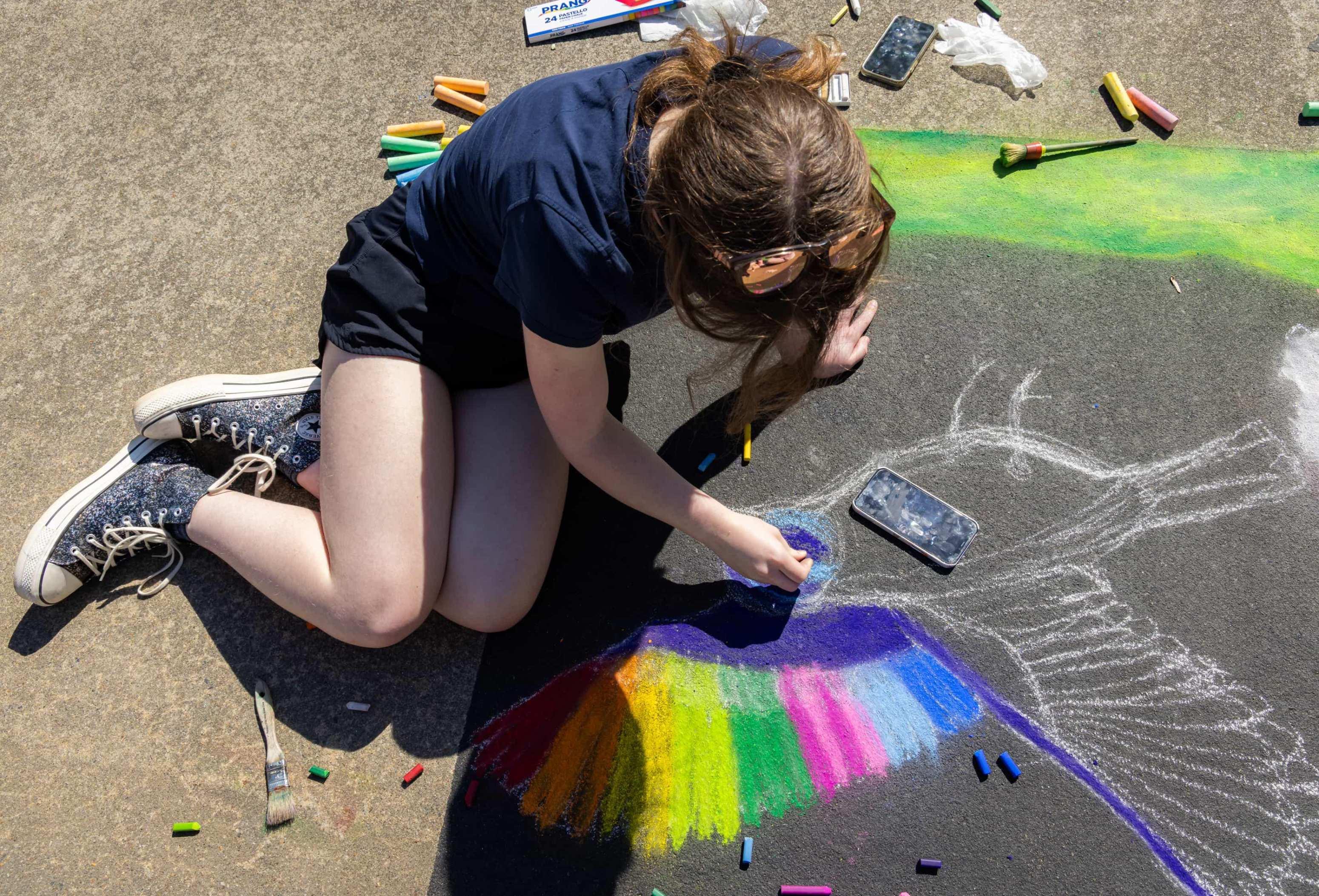 K-12 student creating chalk art / 