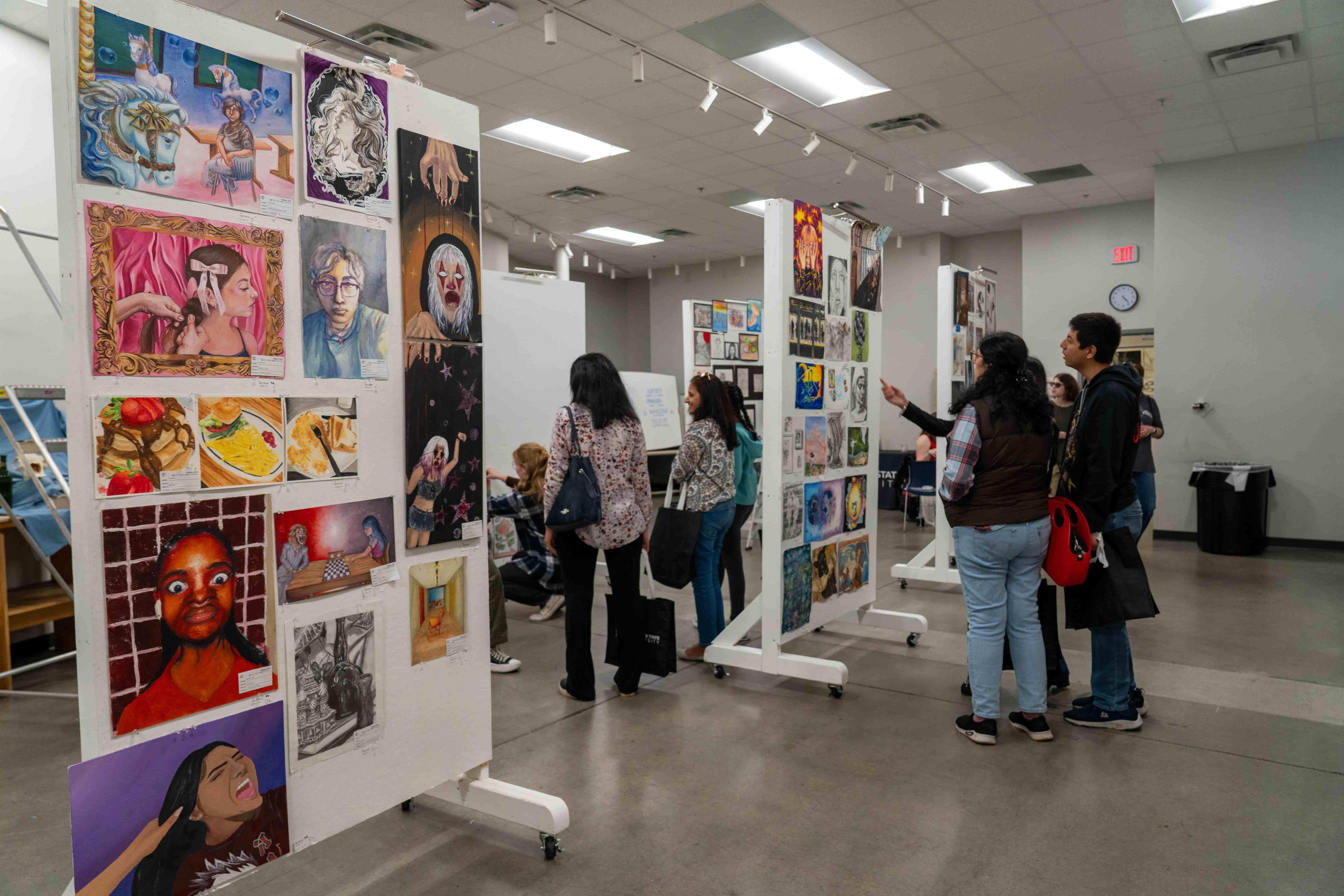 Guests viewing the various artworks on display at the Art Show  / 