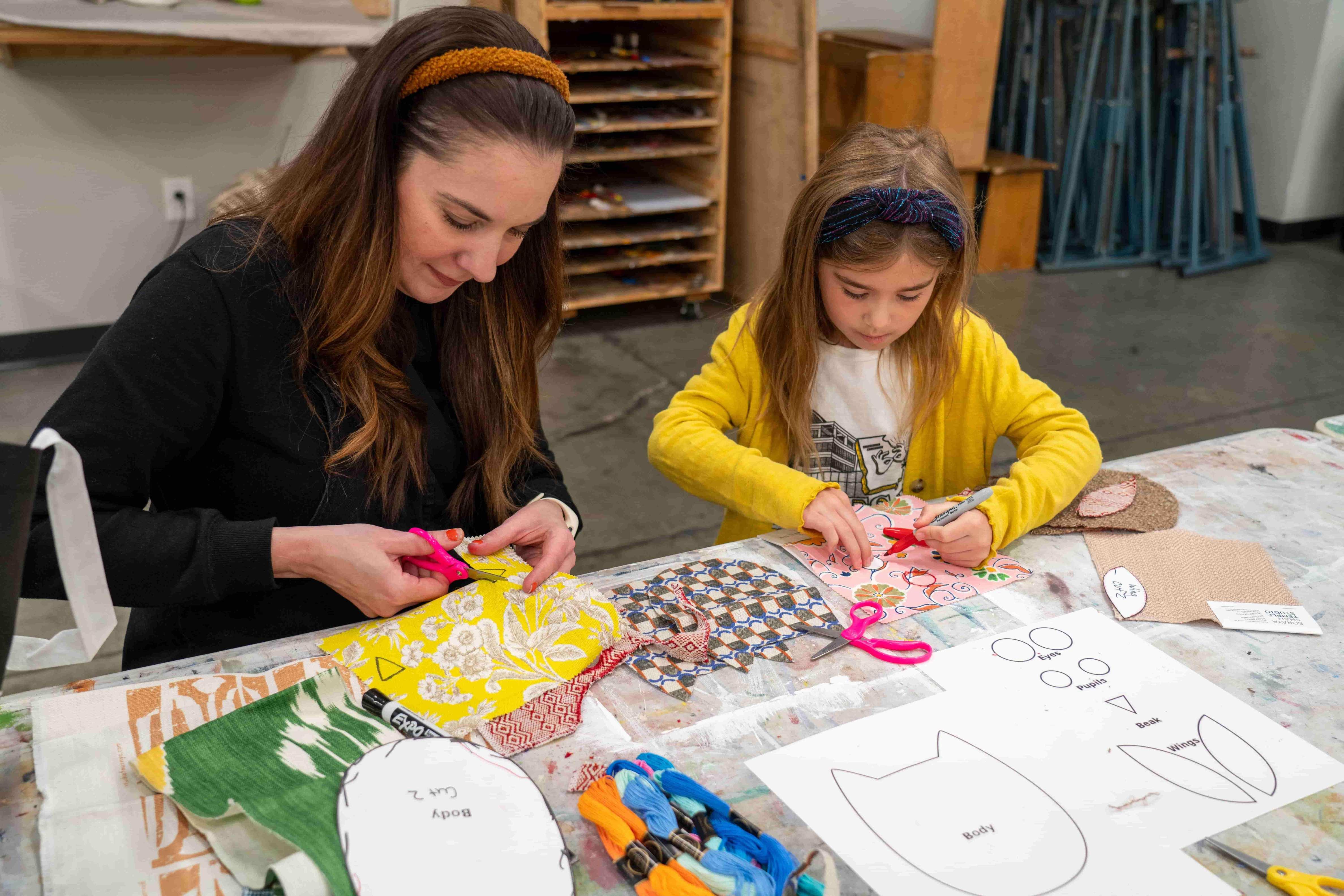 Mother and daughter creating stuffed owls.  / 