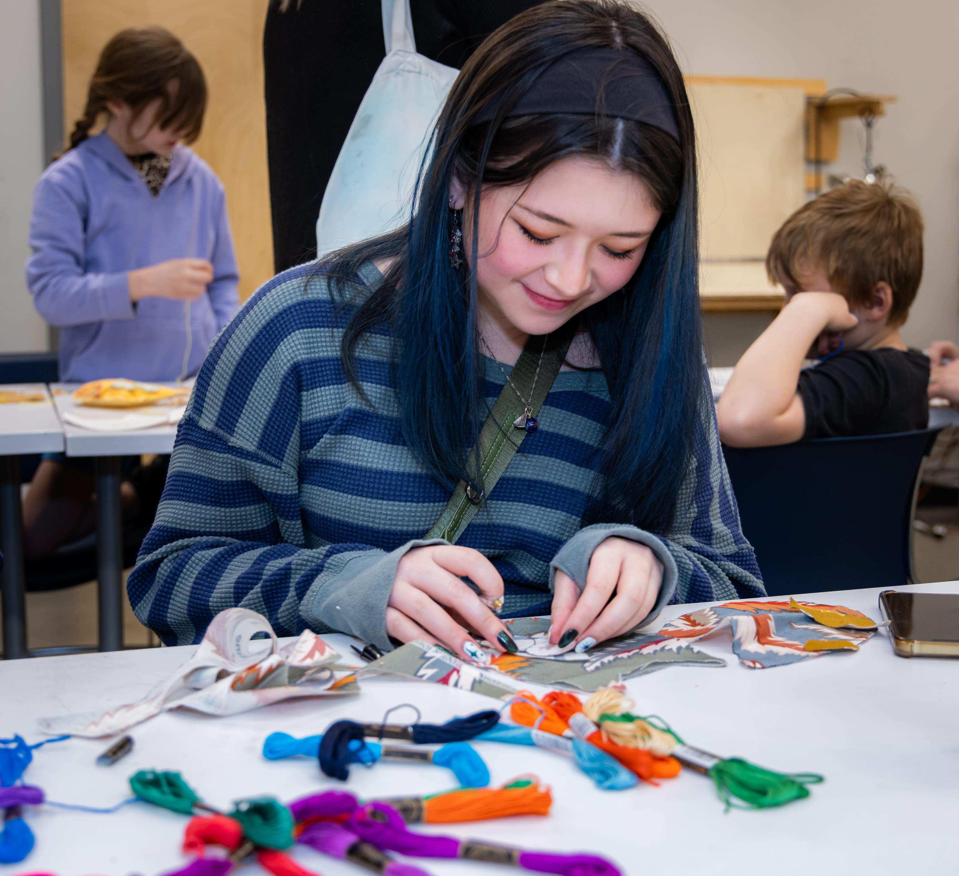 K-12 student sewing stuffed owl / 