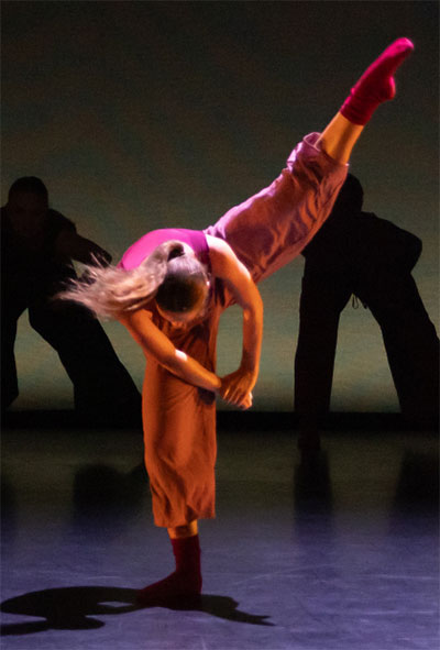 balerina leaning forward head facing ground leg fully extended