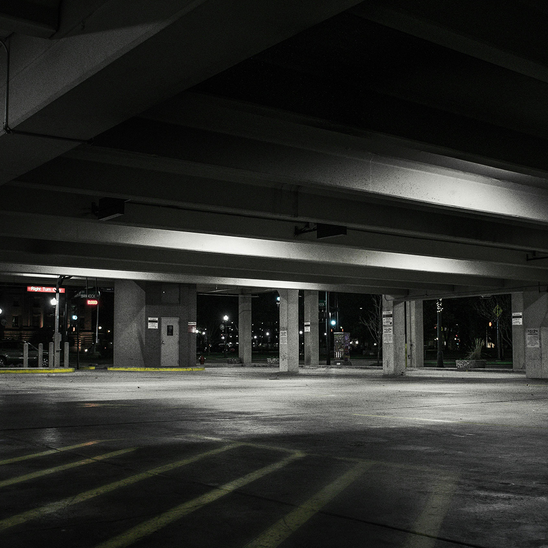 black and white photo of empty parking garage