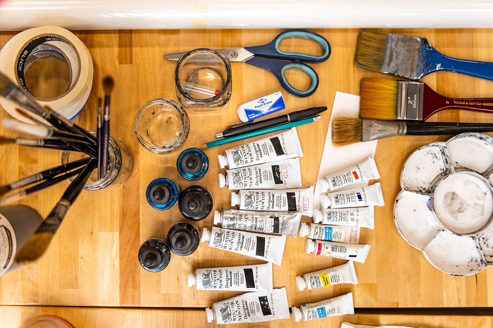 paints and various art supplies on a table