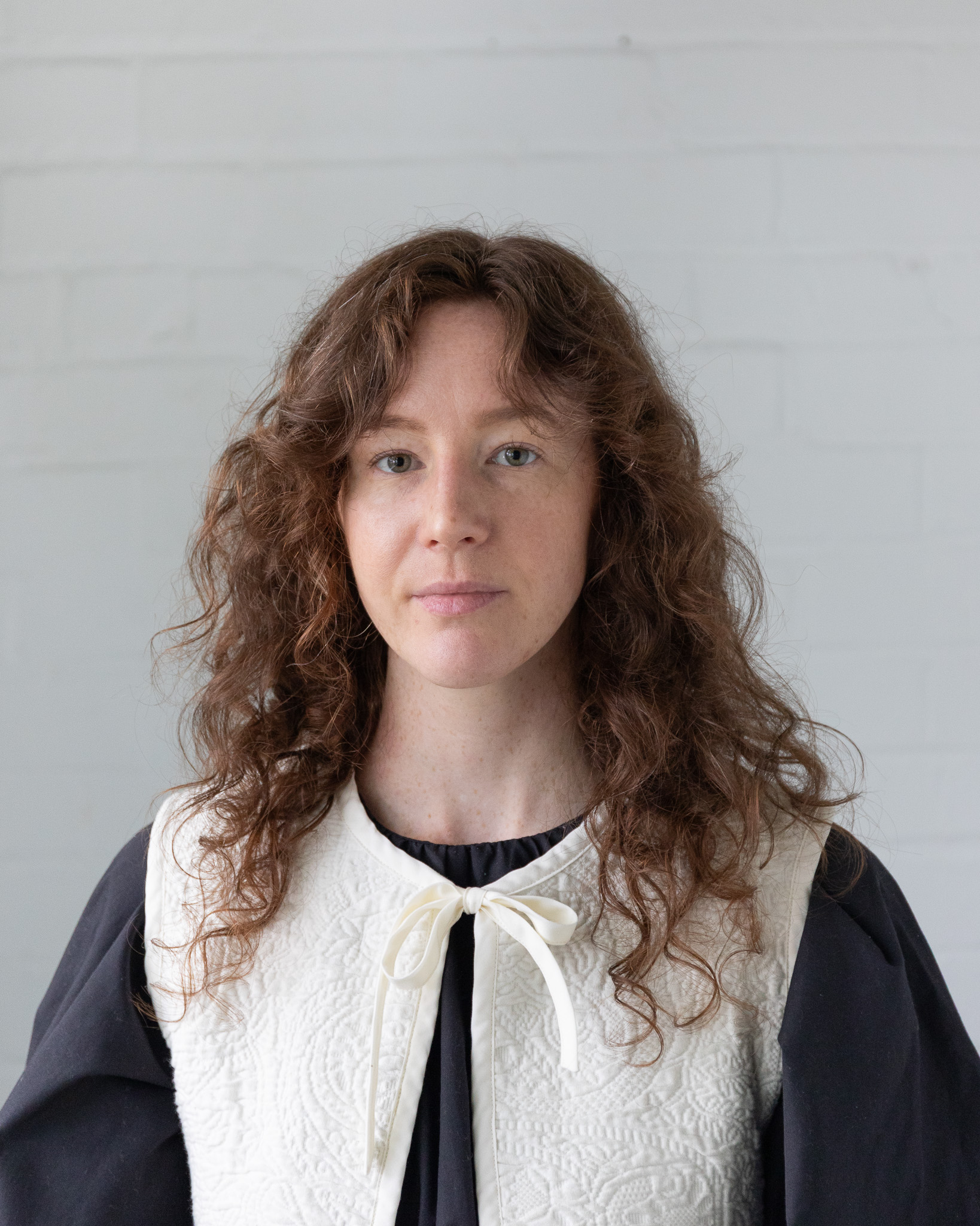 headshot of a woman standing in front of a white background