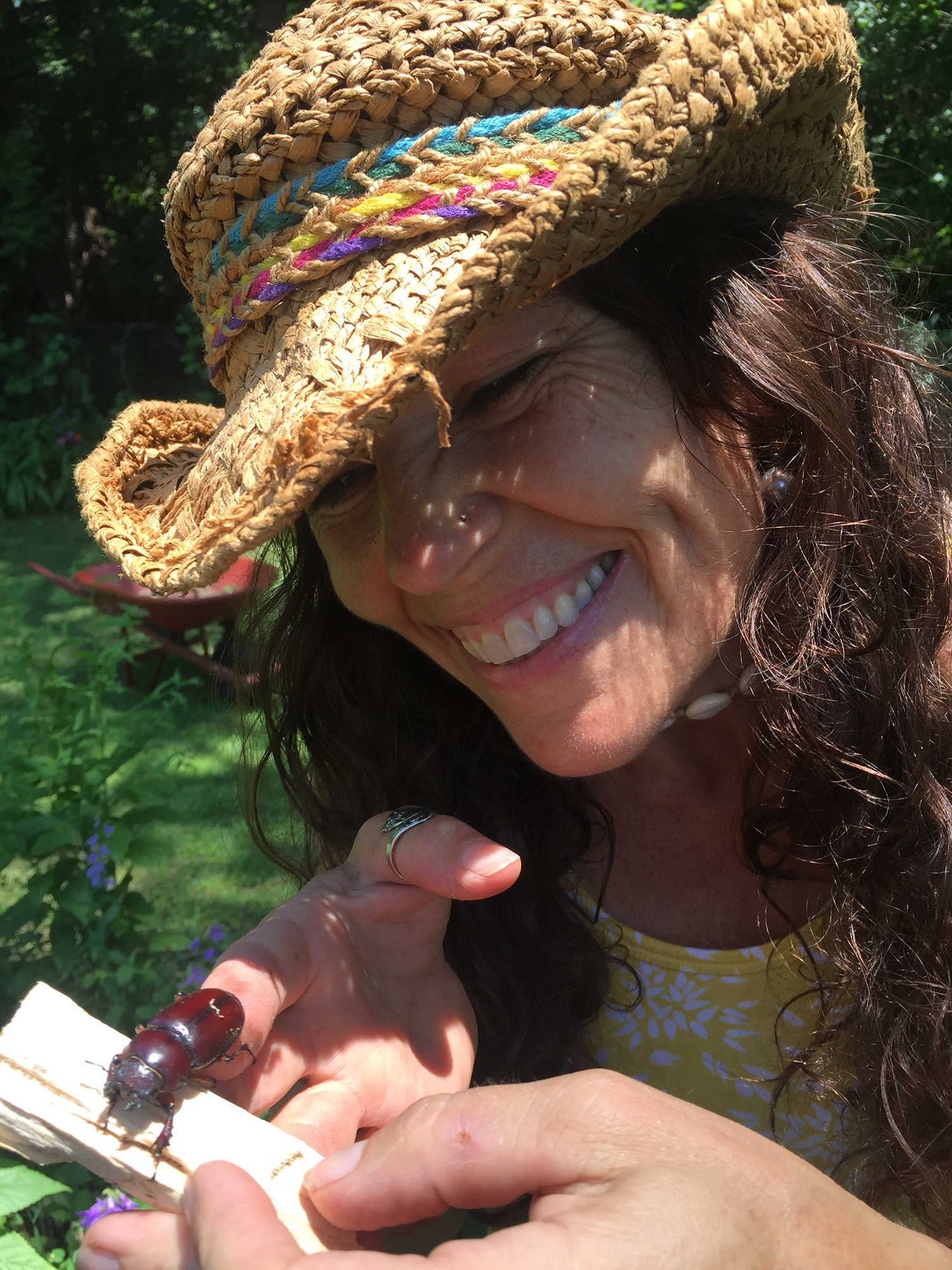 image of woman holding a beetle