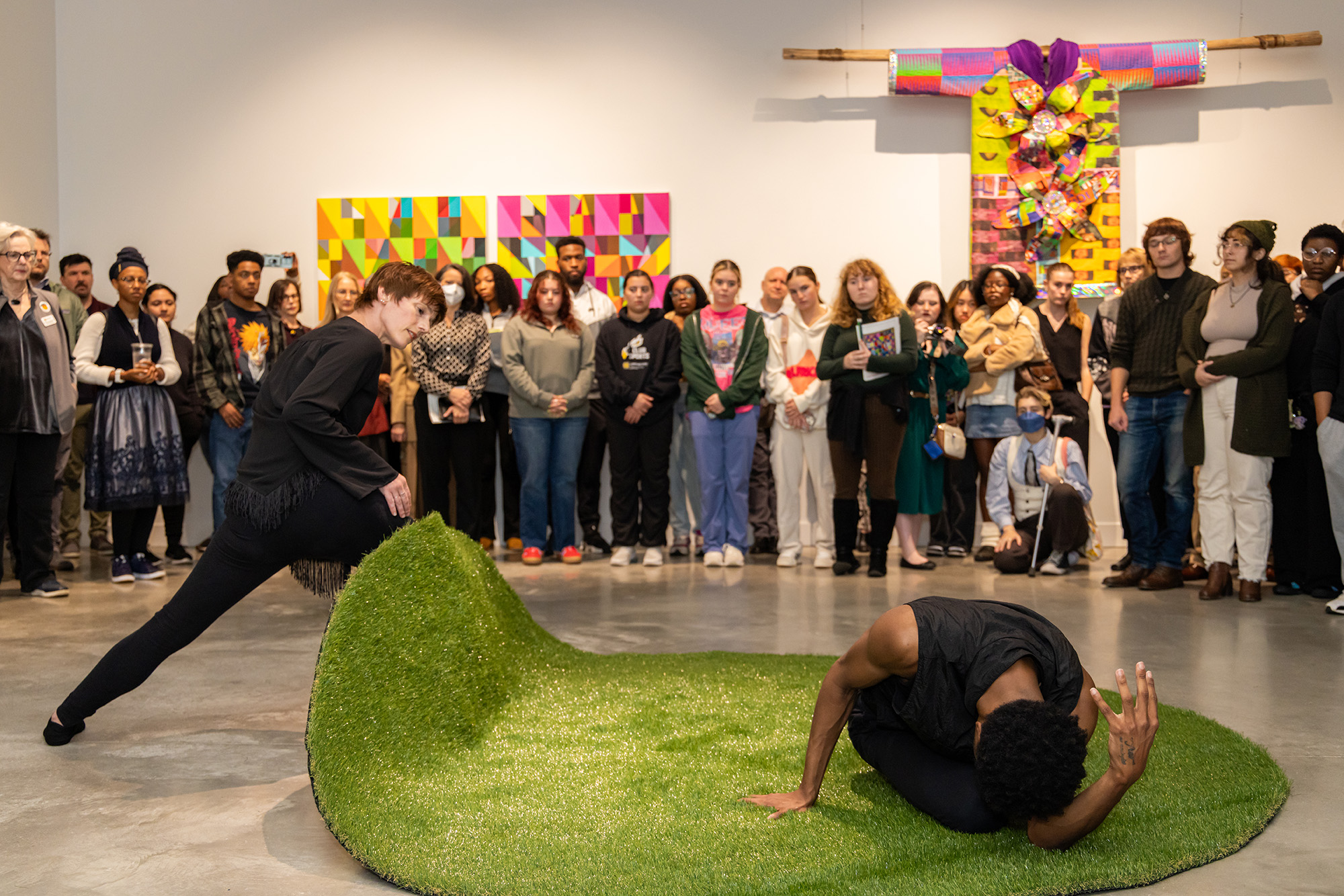 two people performing with a crowd behind them