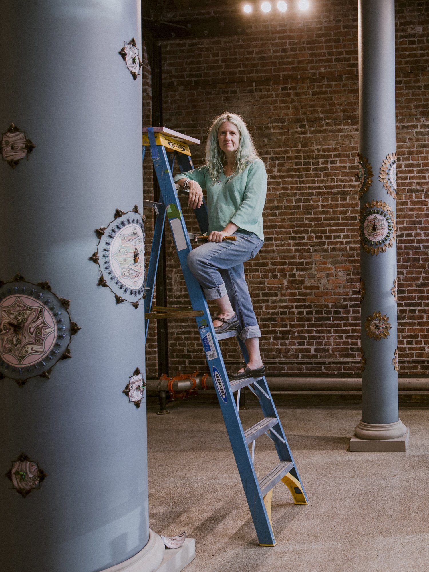woman standing on a ladder