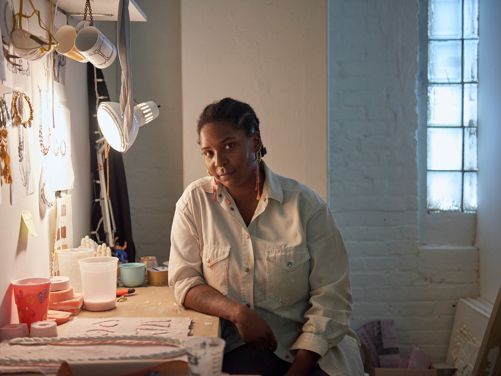 image of a woman leaning over a desk in moody lighting