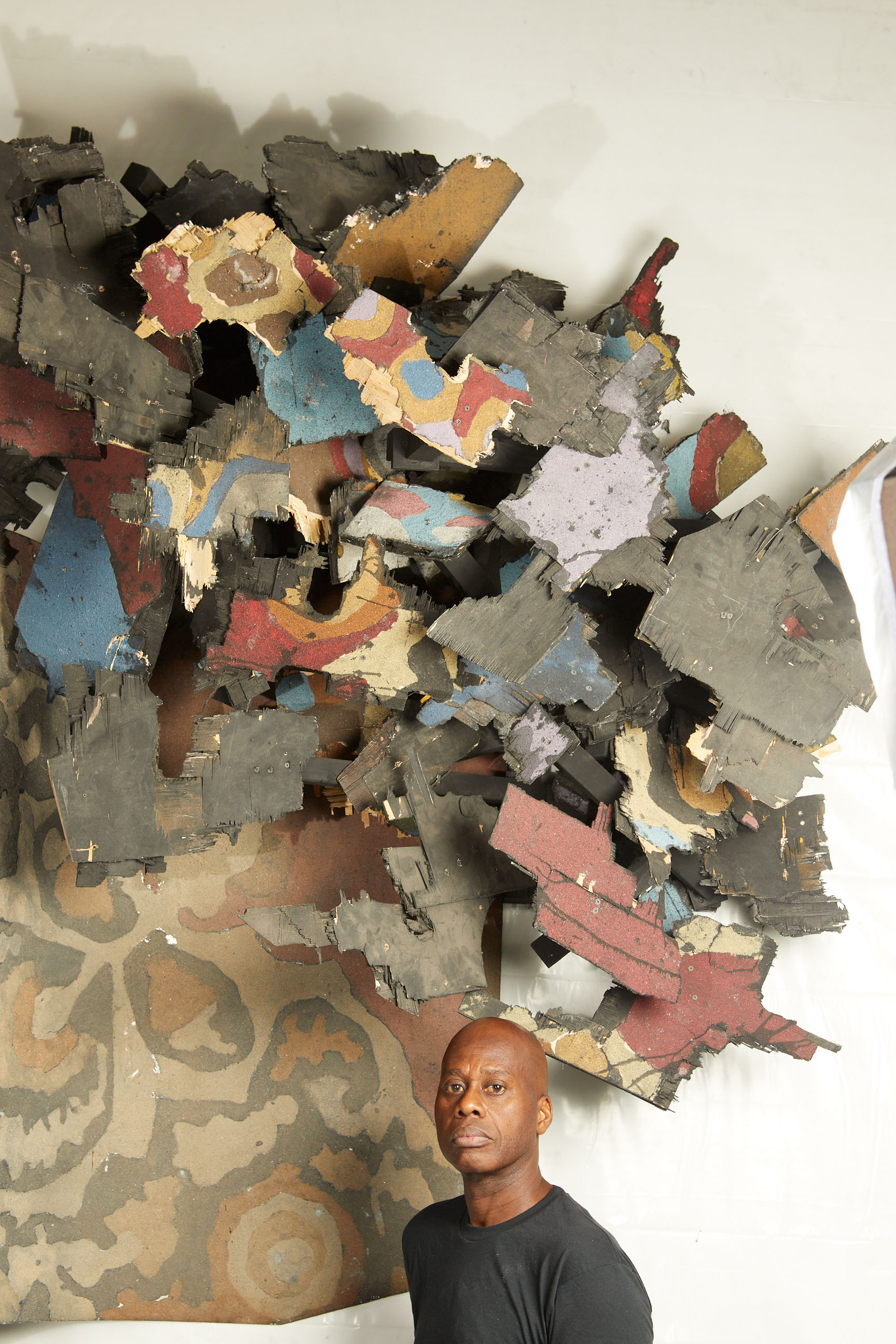 headshot of a man in front of artwork