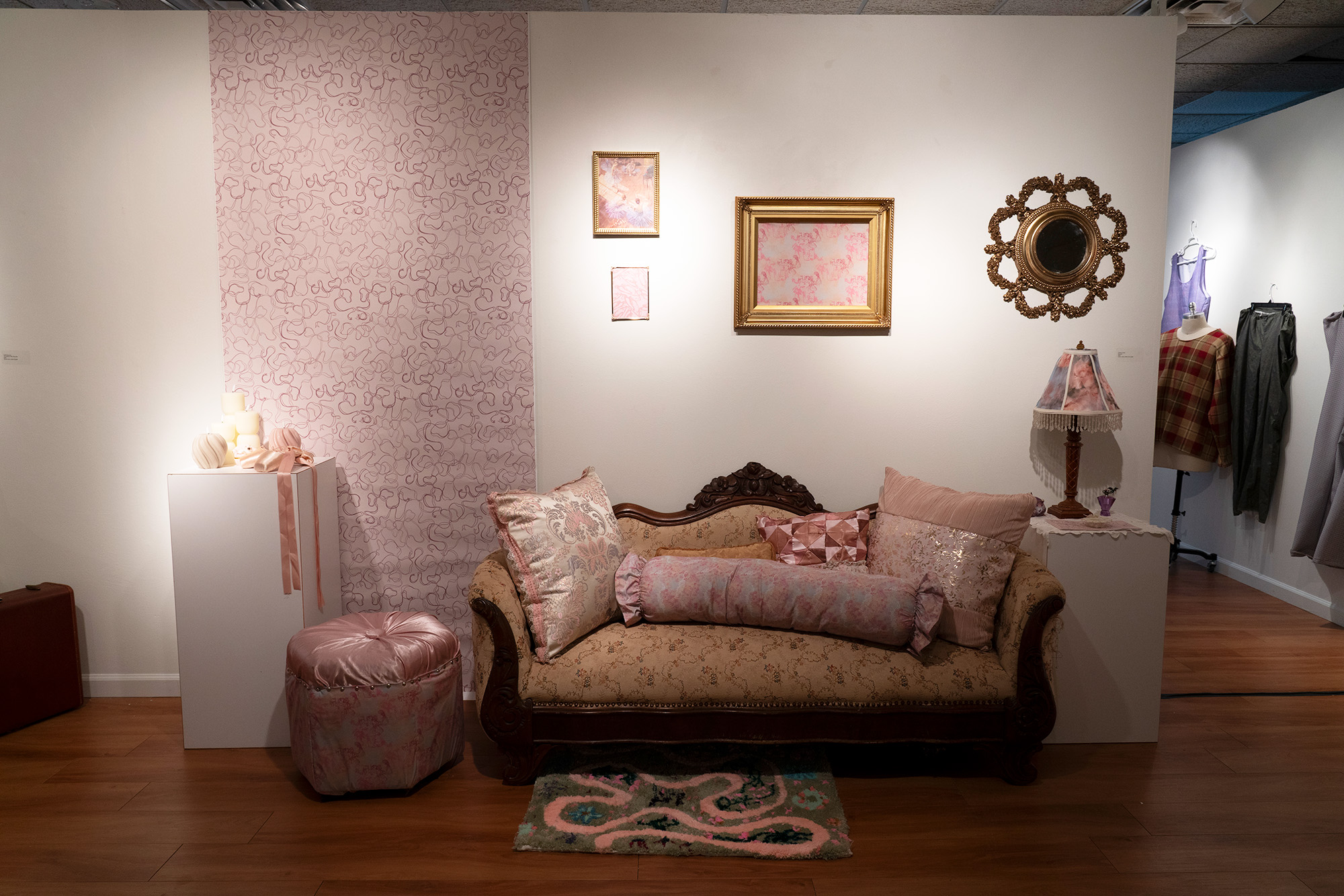 couch and fabrics in front of a gallery wall