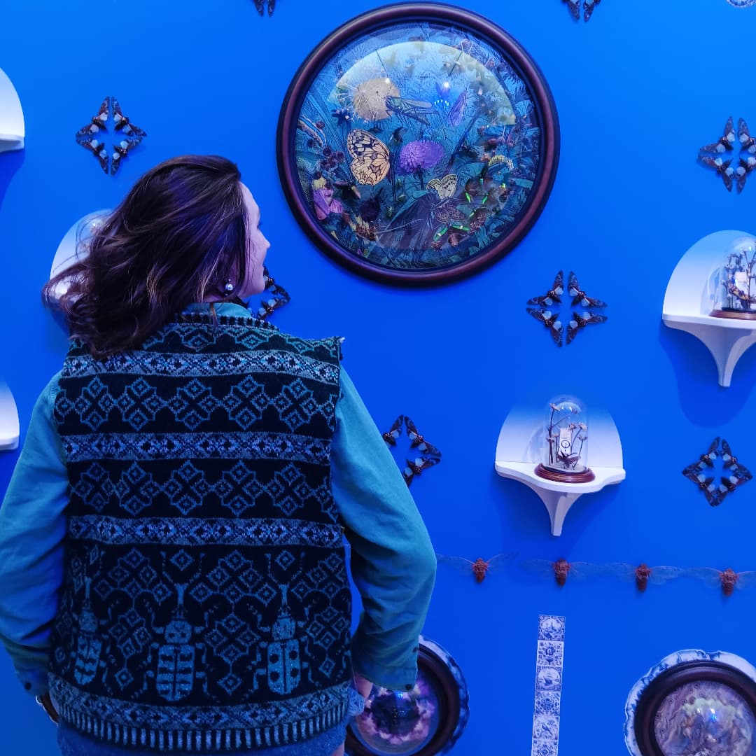 woman wearing a vest in a blue room