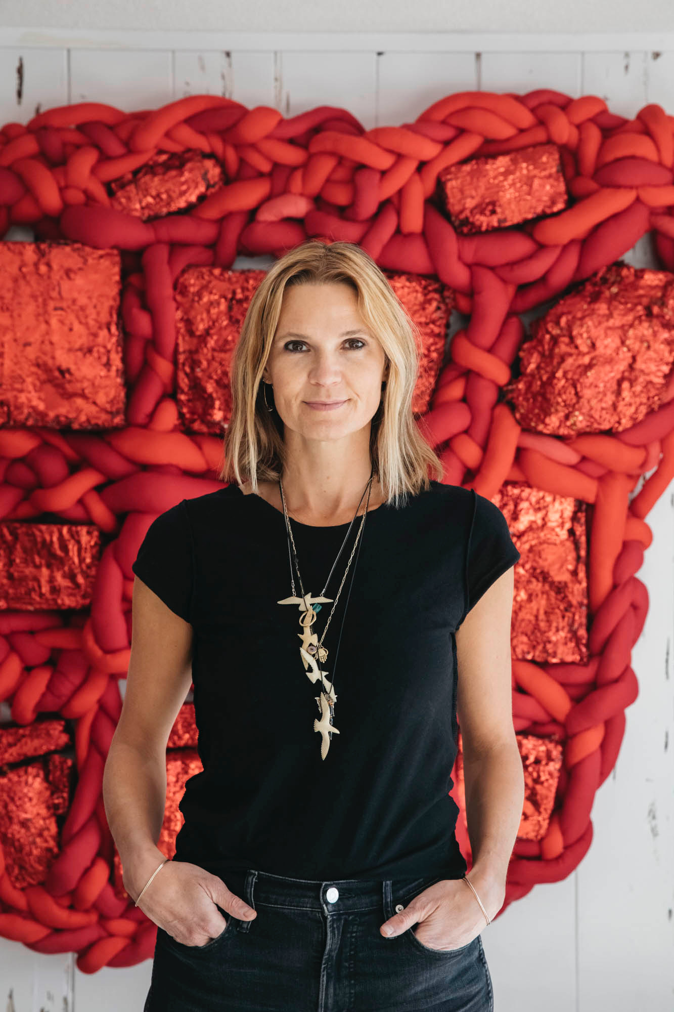 woman standing in front of red backdrop