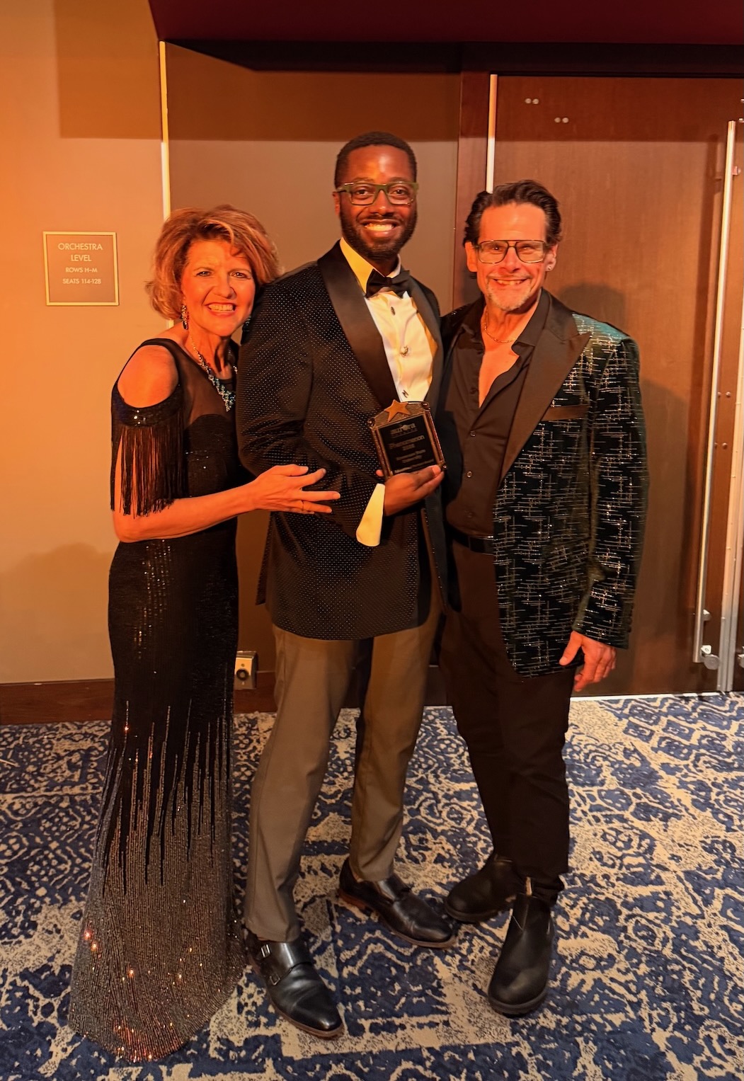 Professor Marlon Burnley accepts award from Aurora Theater