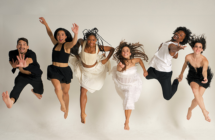 bodytraffic dancers, smiling, in black and white reaching to the camera