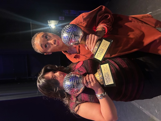 two women pose with dancing with the stars trophies
