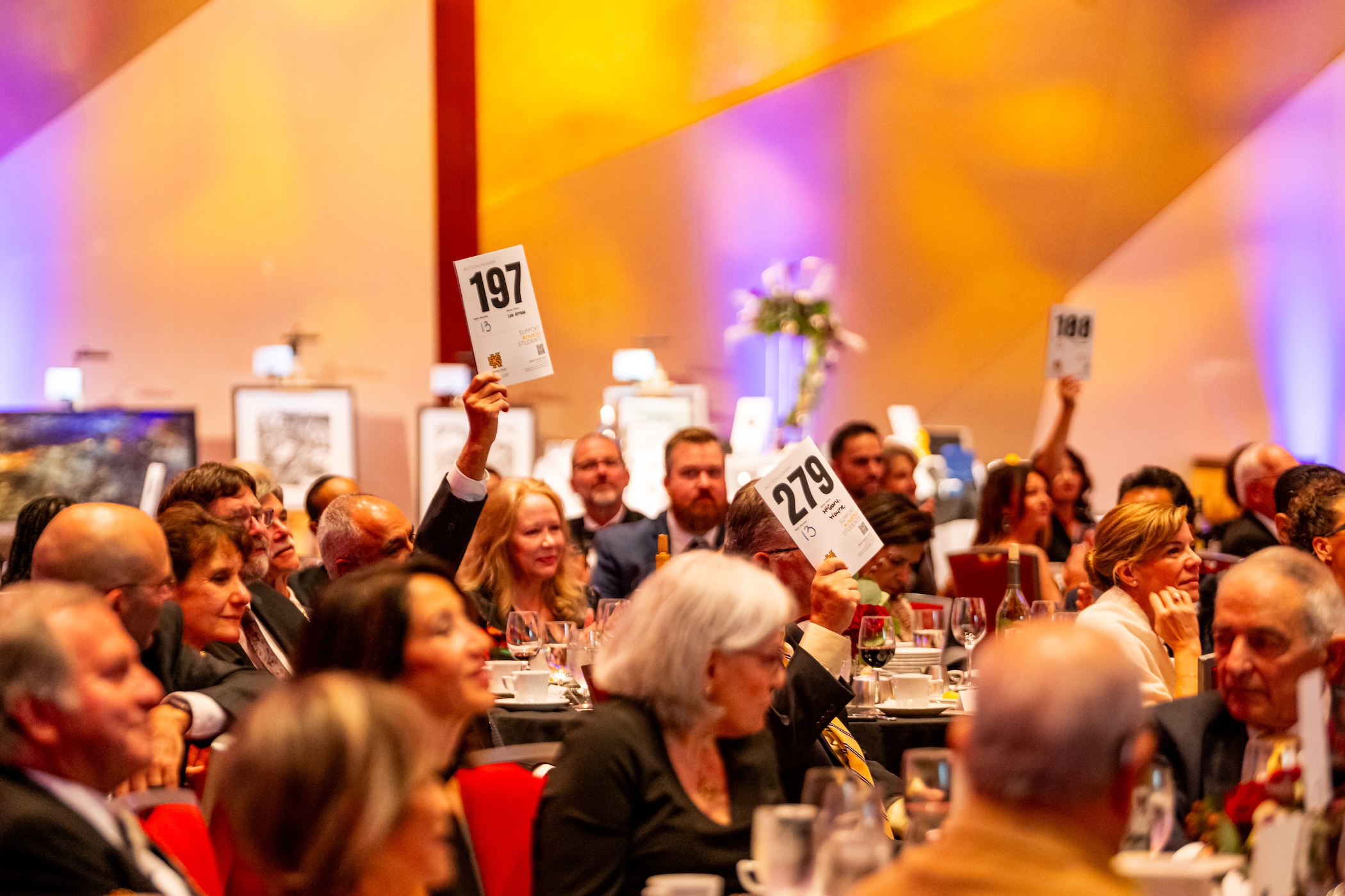 gala guests raise paddles