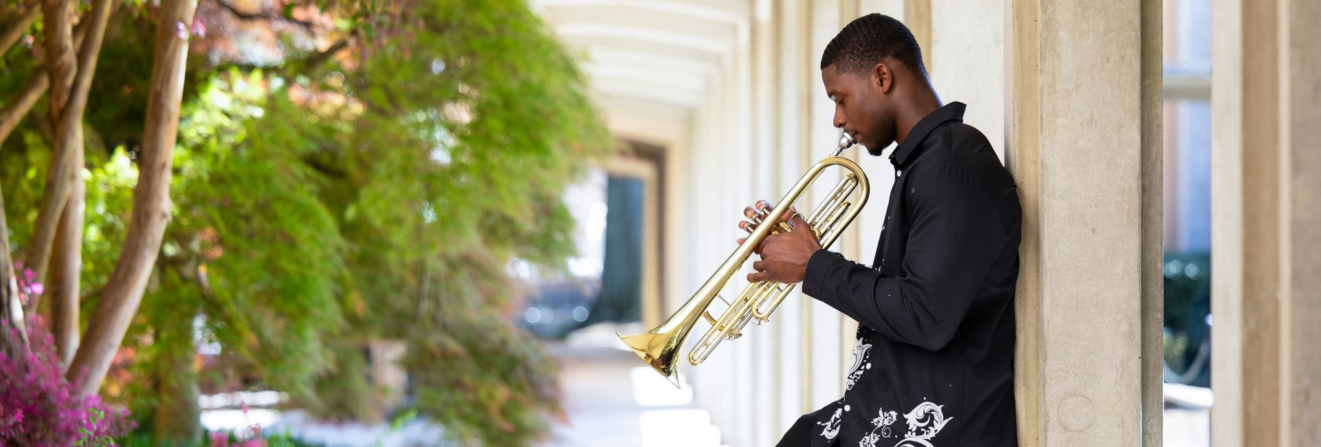landscaping_and_trumpet_player_leaning_on_a_wall