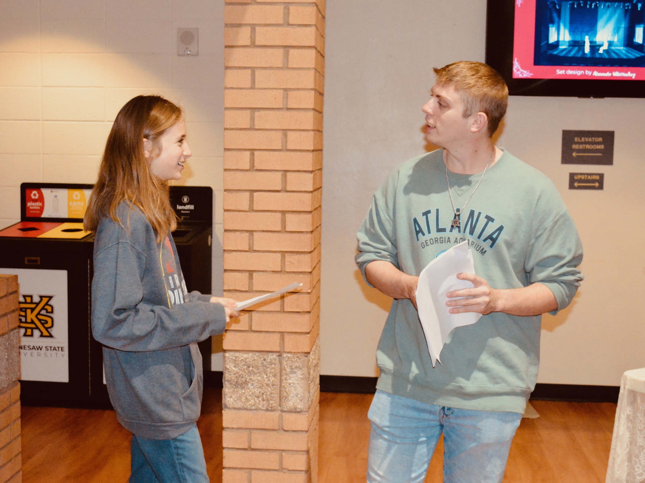 students administer a survey before a theatre production