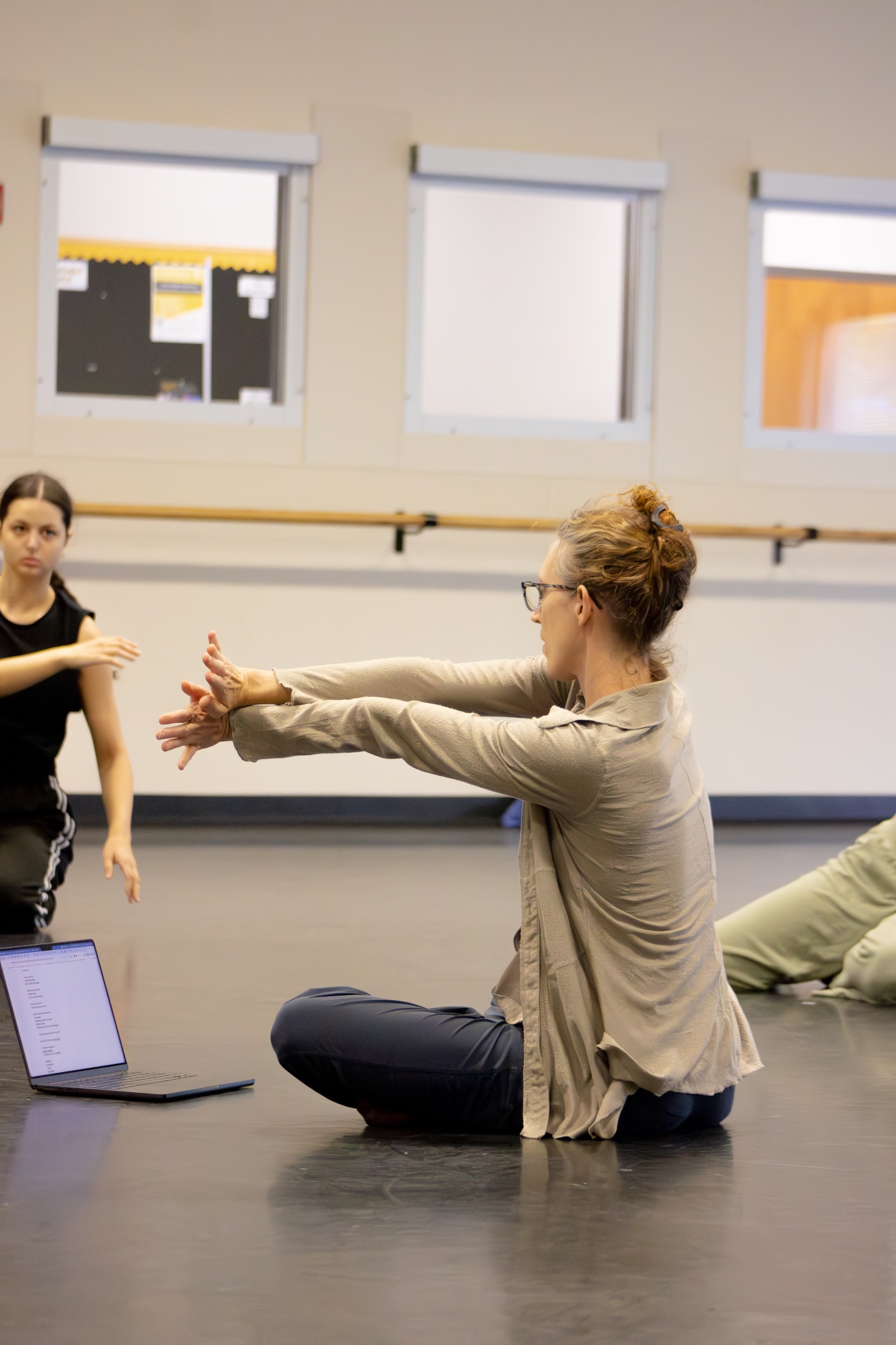 choreographer rehearses with students in the dance studio