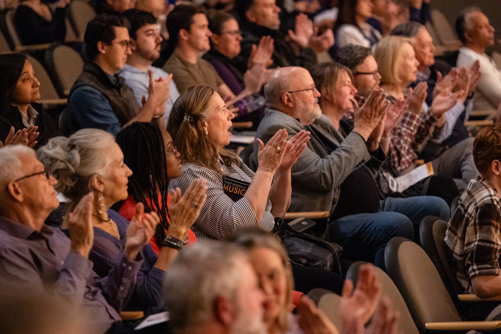 audience members applaud