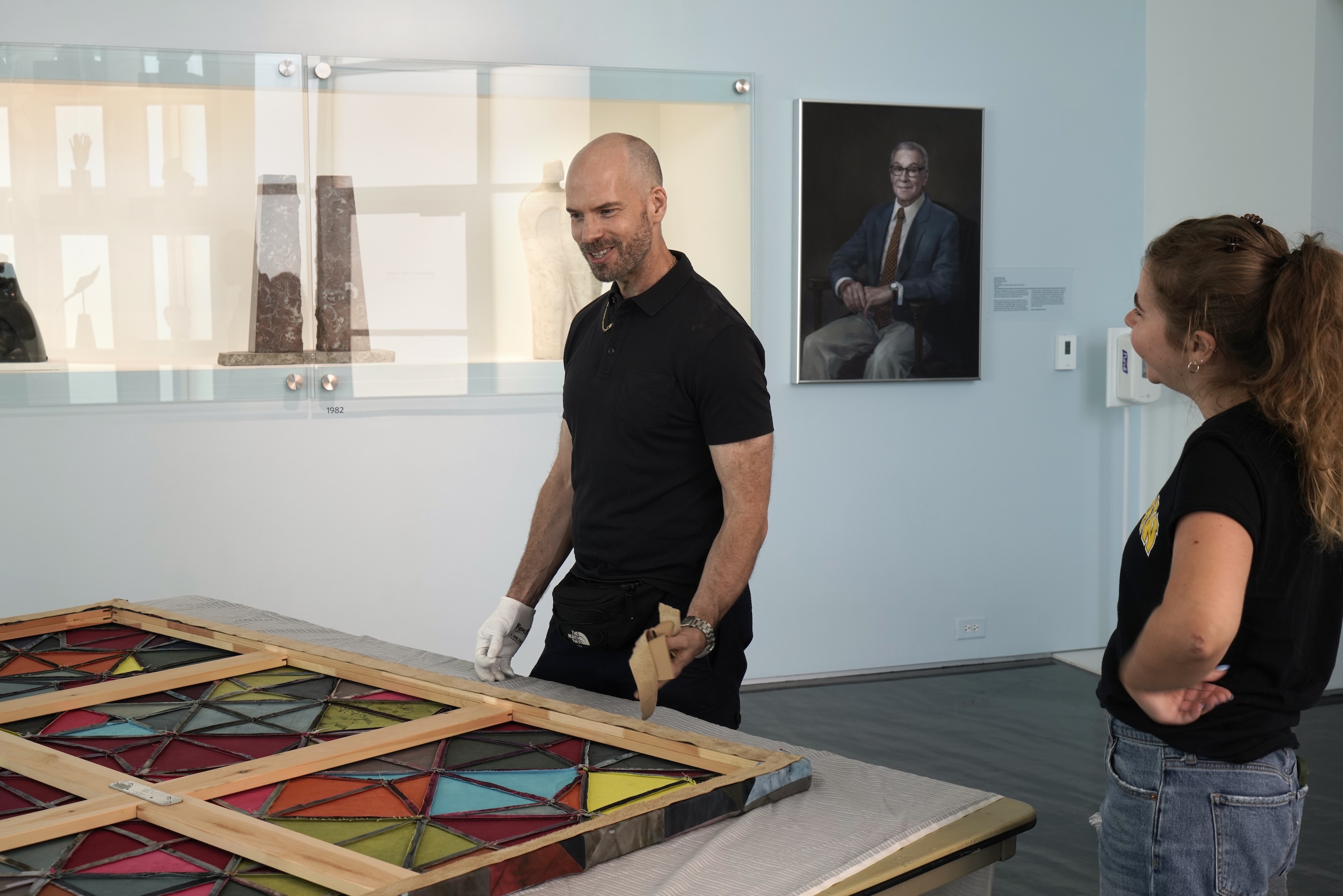 Artist Jonathan Van Dyke works on an installation at the Zuckerman Museum of Art