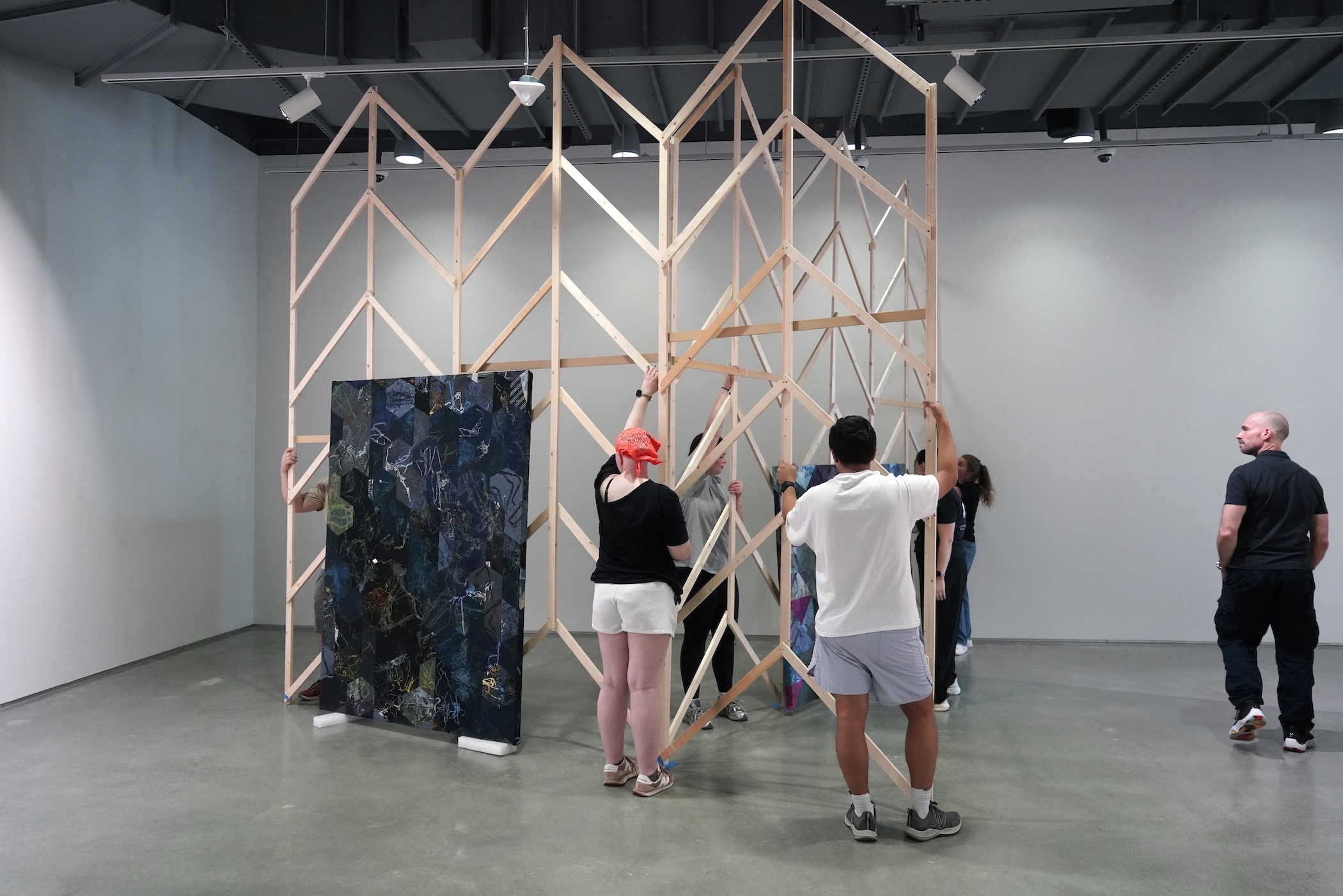 Artist Jonathan VanDyke and the Zuckerman Museum team work on an installation for an exhibit