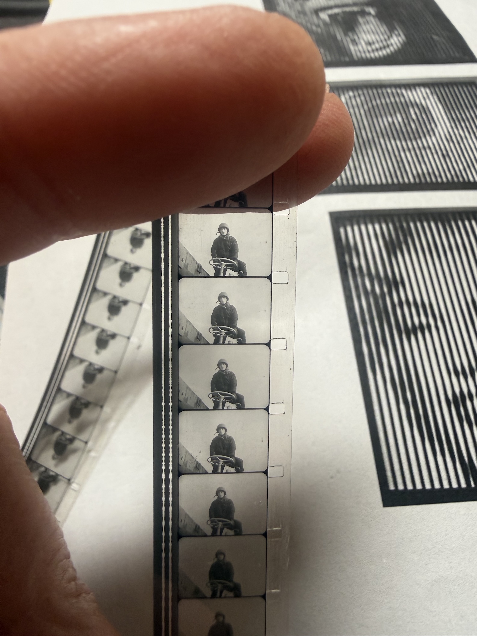 a hand holds strips of film