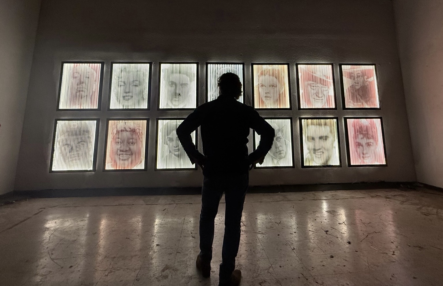man stand in an art gallery