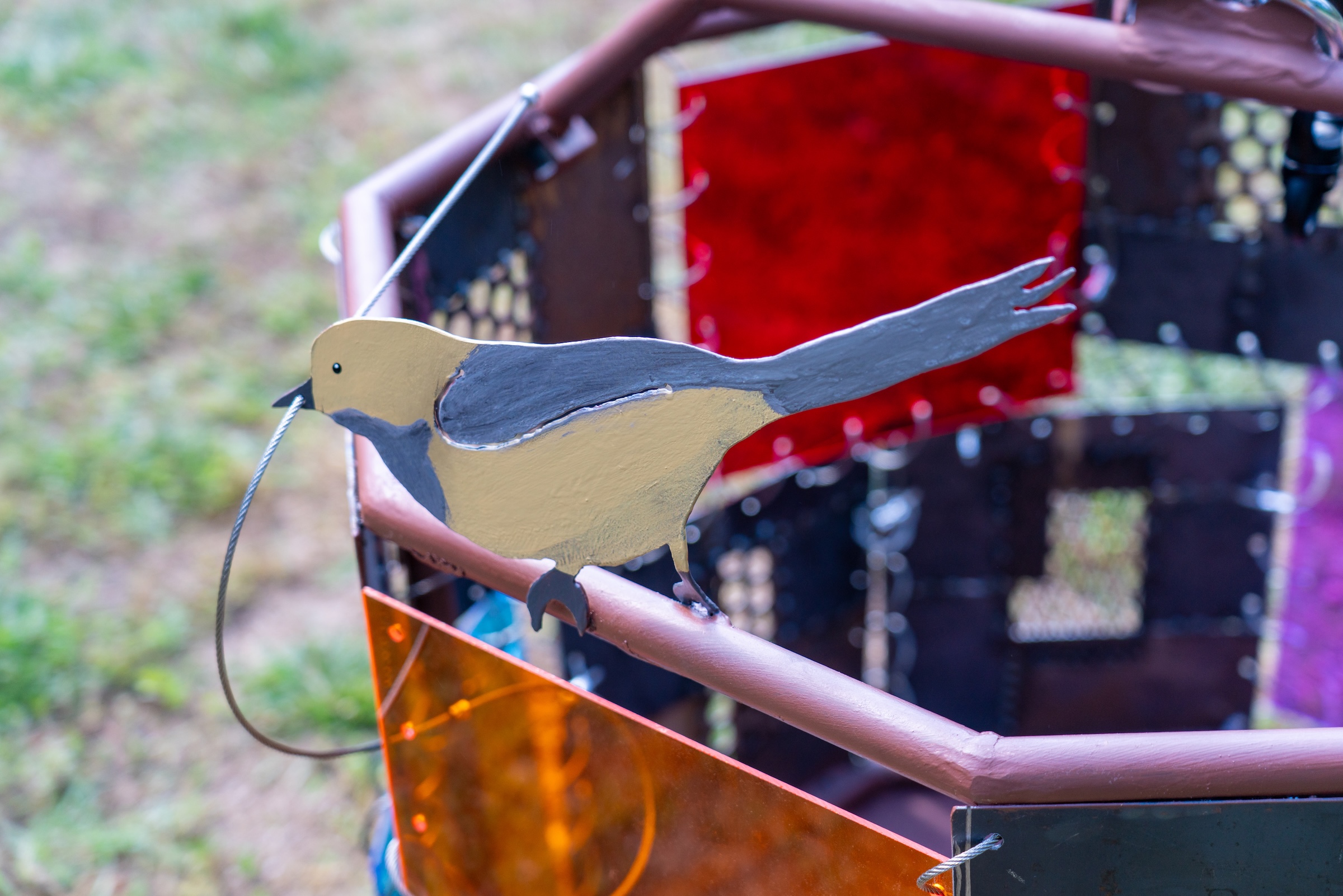 a sculpture depicts an orchard oriole cast from iron