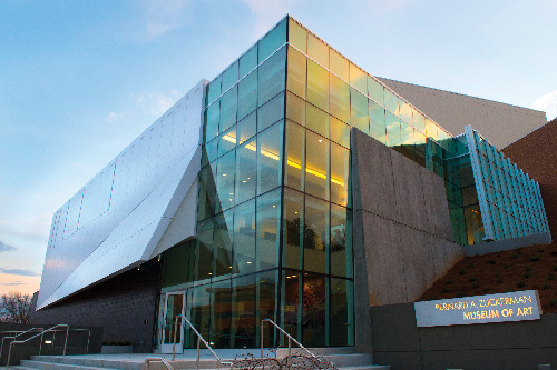 Glass and concrete exterior facade of the Zuckerman Musuem at sunset.