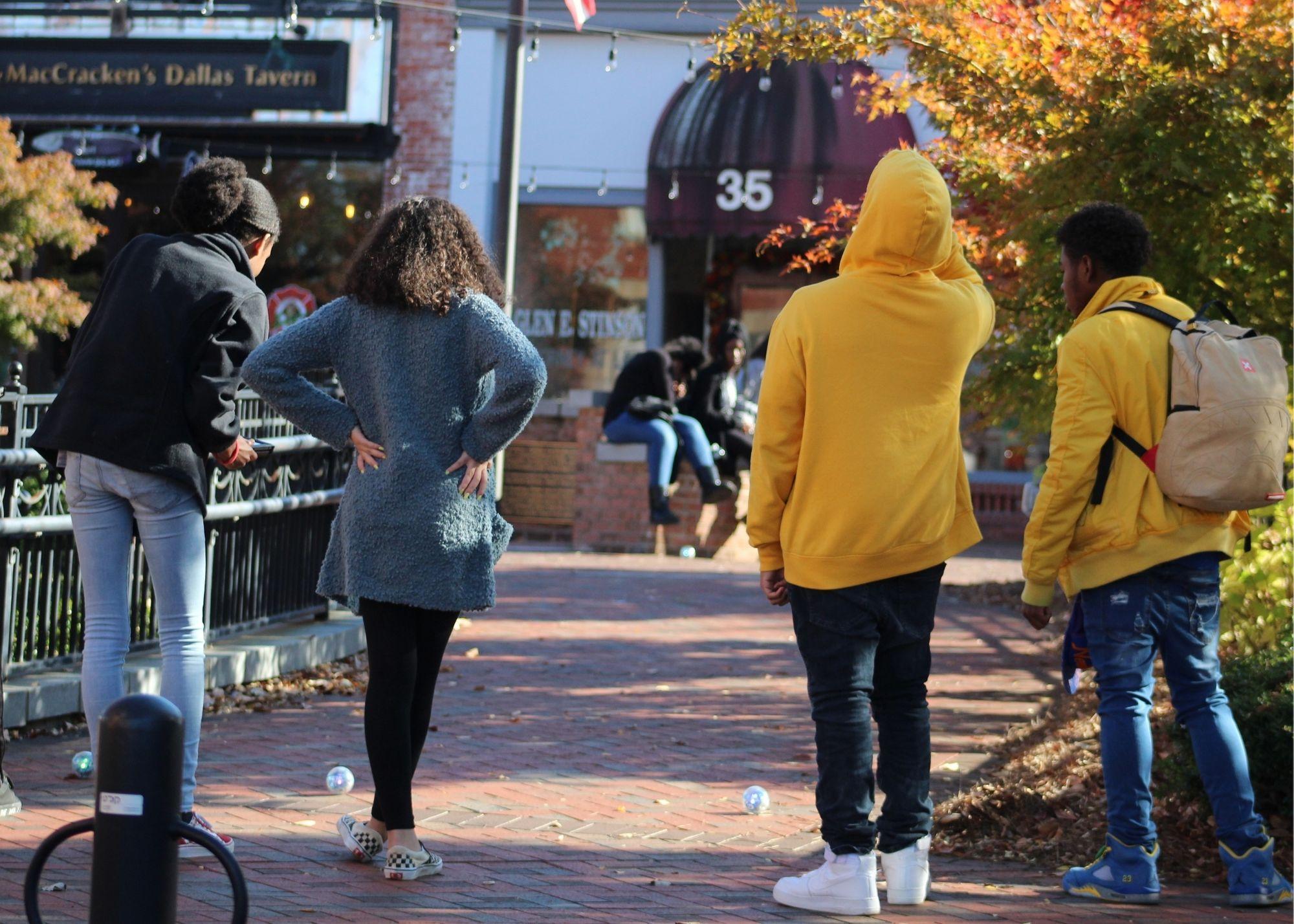 People standing outside a tavern, with an autumn scenery  / KSU TRiO students learn basic programming concepts and different career options. 