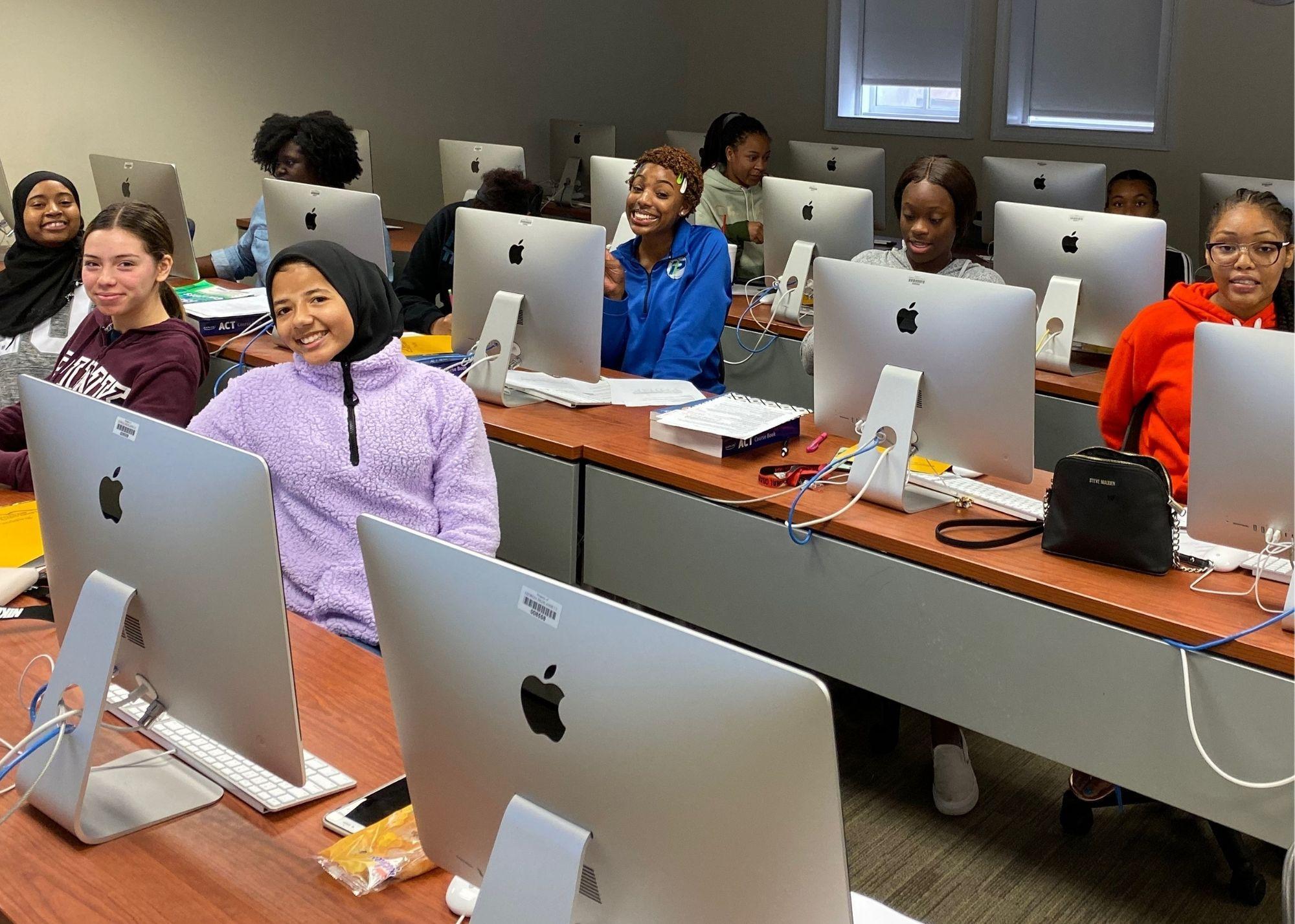 Students sitting in front of desktop computers in a classroom setting  / ACT Test Prep Boot Camp that aims to not only prepare high school students for the big test that will determine their college entrance, but they are also working to prepare students for life in the community. The Boot Camp is a 10-week commitment that takes place every Saturday, and students that give up their weekends gain confidence for their ACT Test and learn soft skills that will benefit them in their future workplaces, such as timeliness, work ethic, and accountability. 