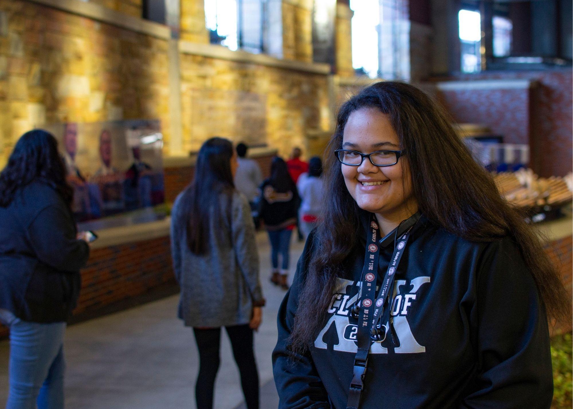 A student smiling at Suntrust Park  / KSU TRiO Upward Bound at Rockmart and Cedartown High Schools visit the Suntrust Park to learn about stadium construction and architecture. 