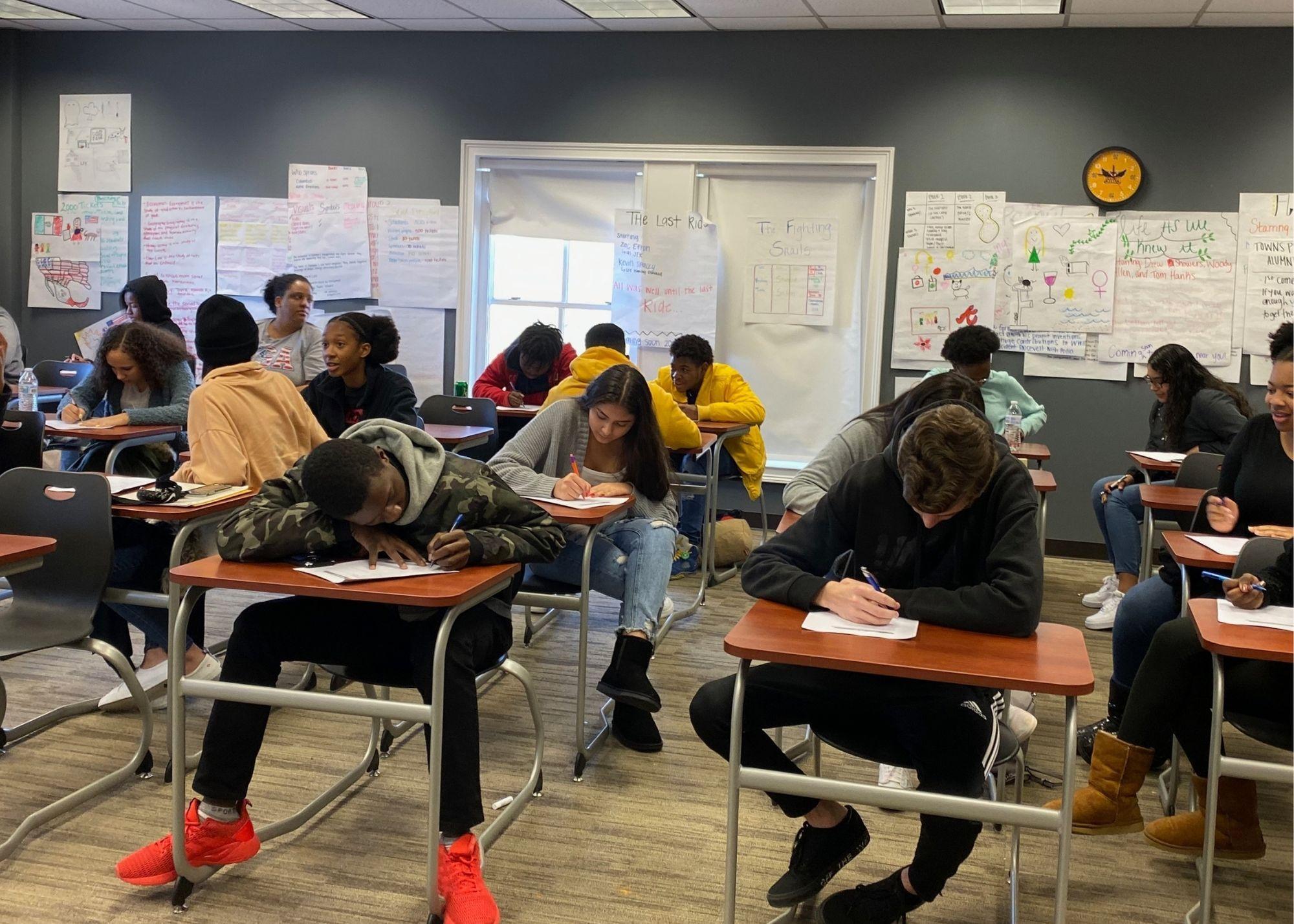 Students sitting at desks taking an exam in a classroom setting  / ACT Test Prep Boot Camp that aims to not only prepare high school students for the big test that will determine their college entrance, but they are also working to prepare students for life in the community. The Boot Camp is a 10-week commitment that takes place every Saturday, and students that give up their weekends gain confidence for their ACT Test and learn soft skills that will benefit them in their future workplaces, such as timeliness, work ethic, and accountability. 