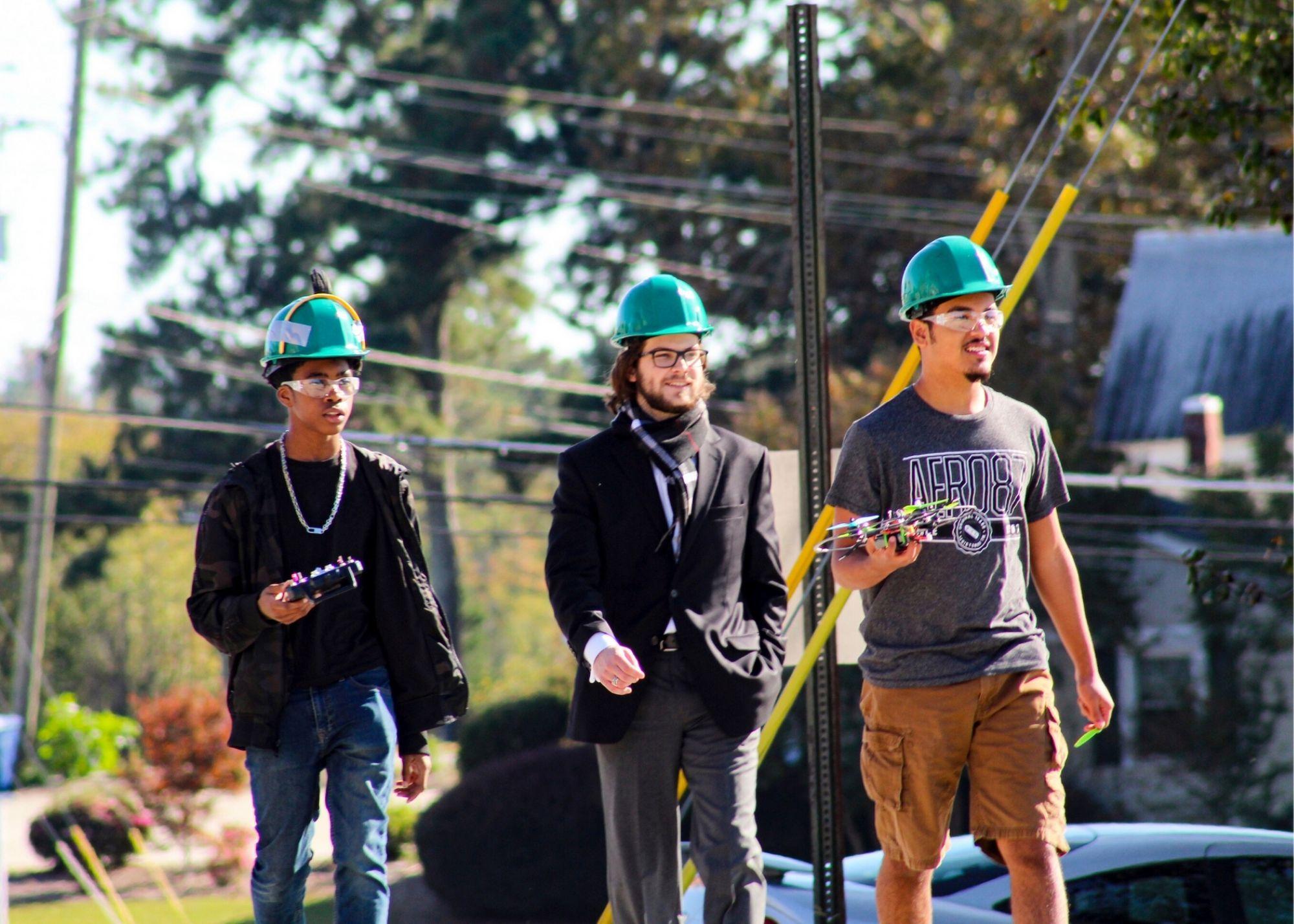 Students wearing hardhats, learning about drone flying  / KSU TRIO's groundbreaking Drone Program introduces students to the basics of drone flying, ethics, and mechanics, and the program gives students the opportunity to test for their FAA Pilot's License 
