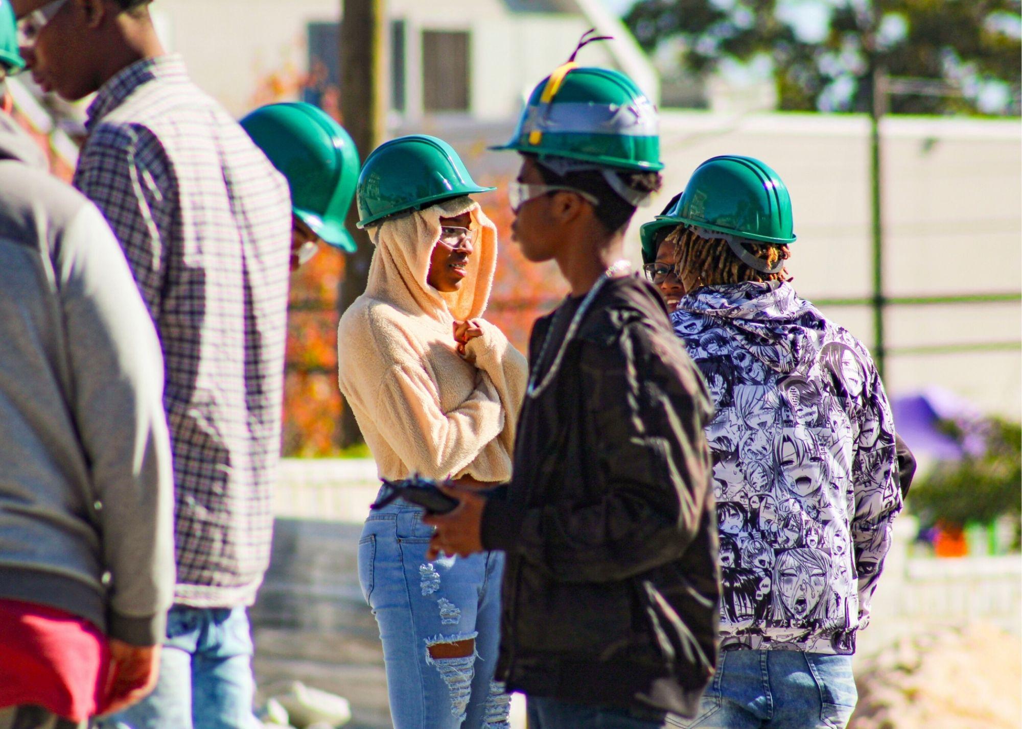 Students wearing hardhats learning about drone flying  / KSU TRIO's groundbreaking Drone Program introduces students to the basics of drone flying, ethics, and mechanics, and the program gives students the opportunity to test for their FAA Pilot's License 