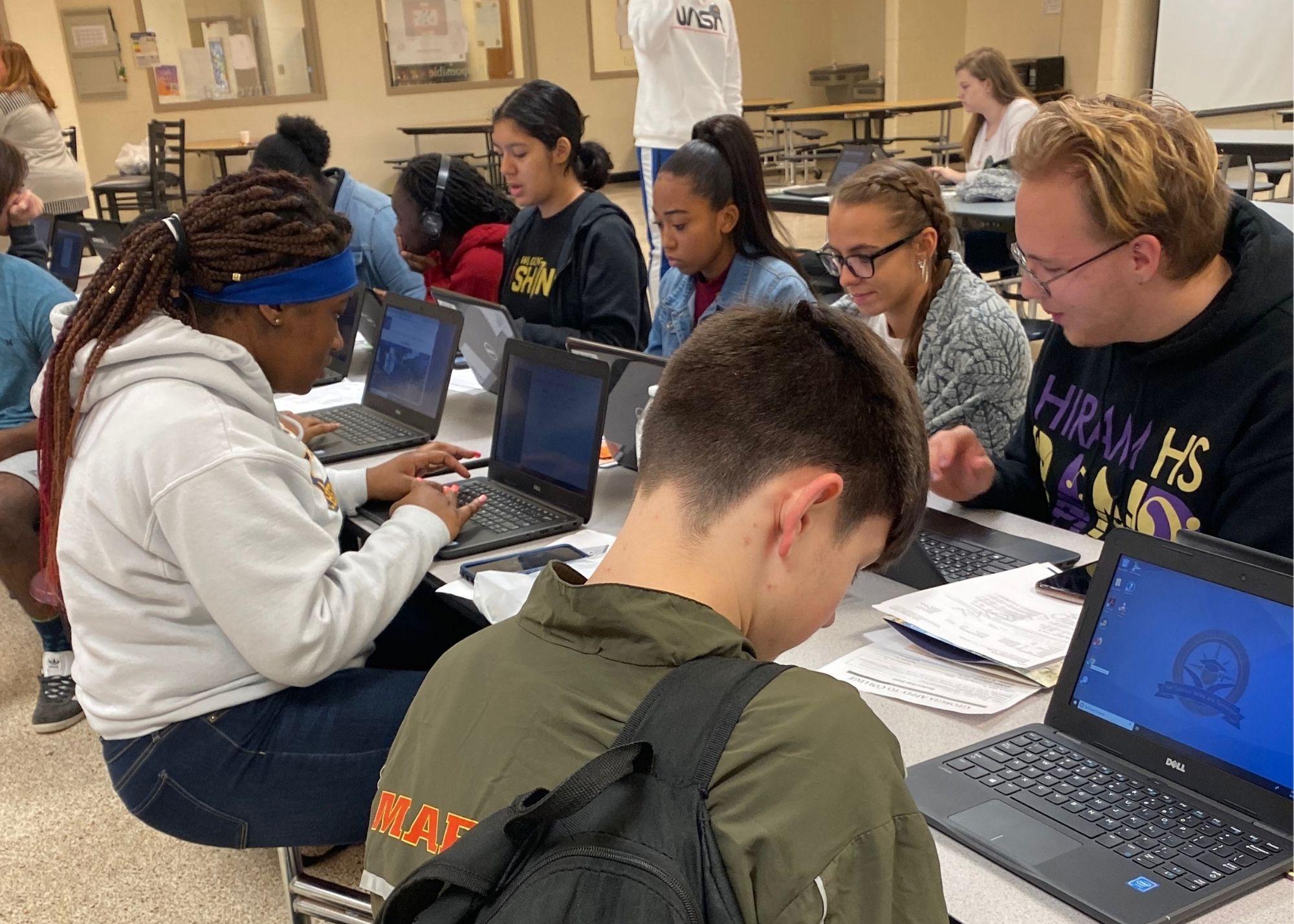 Students sitting at a table, using laptops.  / Hiram High School Upward Bound begins registration and career planning. 