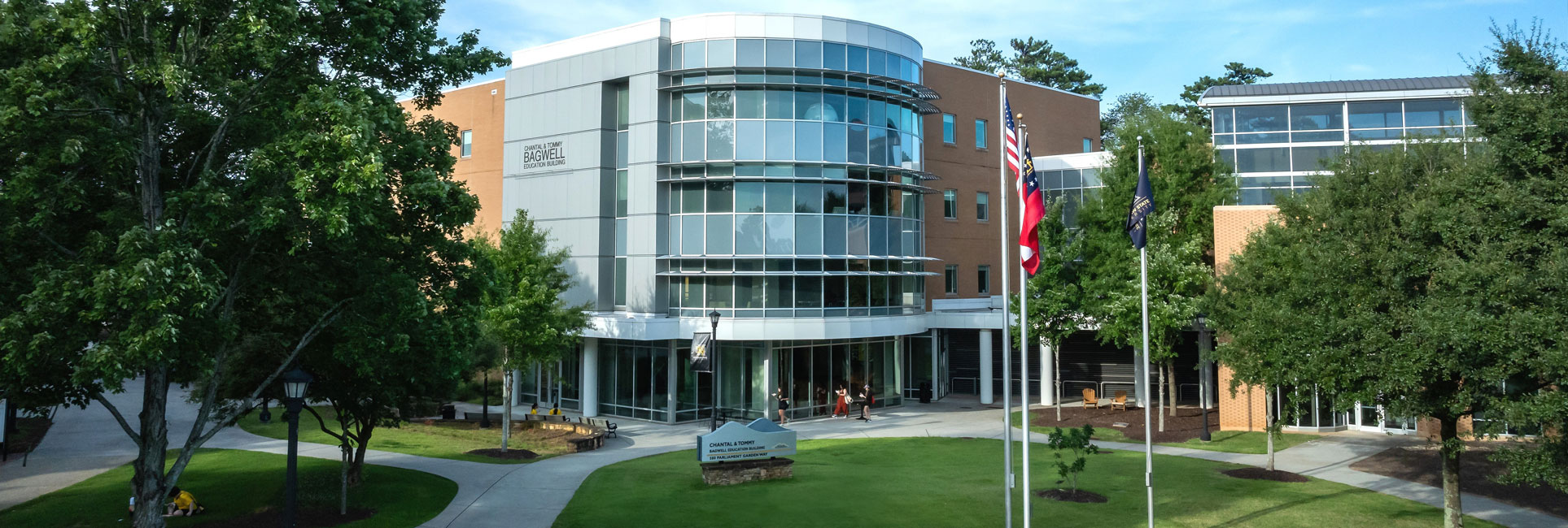 Kennesaw State University's Bagwell College of Education building, featuring a curved glass entrance and a mix of brick and metal exterior.