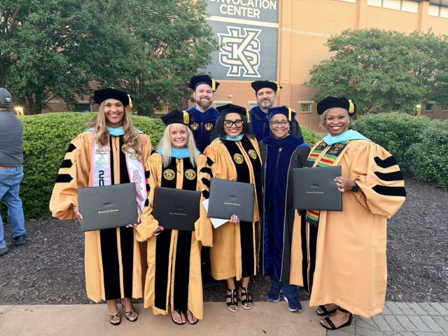 Educational Leadership Doctoral Graduates standing with degrees from Bagwell College.