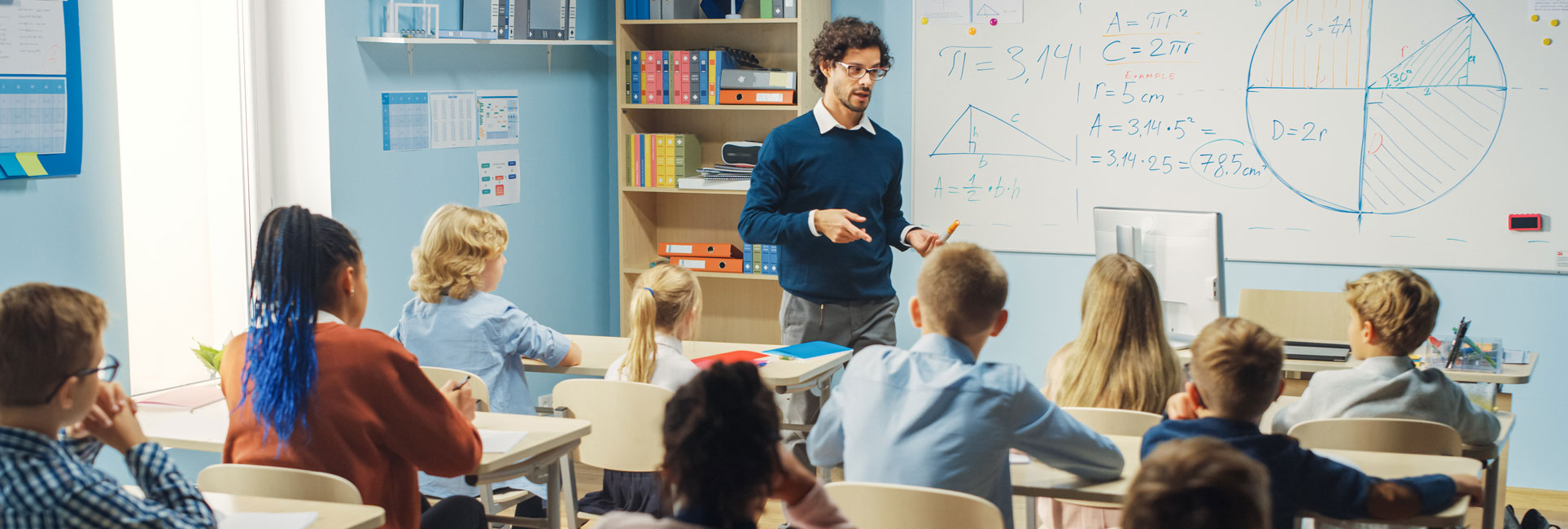 A teacher delivers an engaging lesson to a class of middle school children, promoting active participation and learning.
