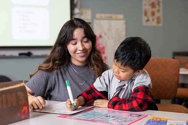 elementary education teacher and student in class