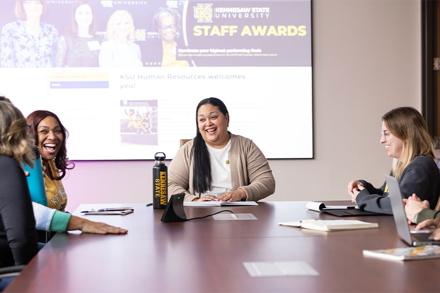 ksu hr faculty sitting at a table collaborating.